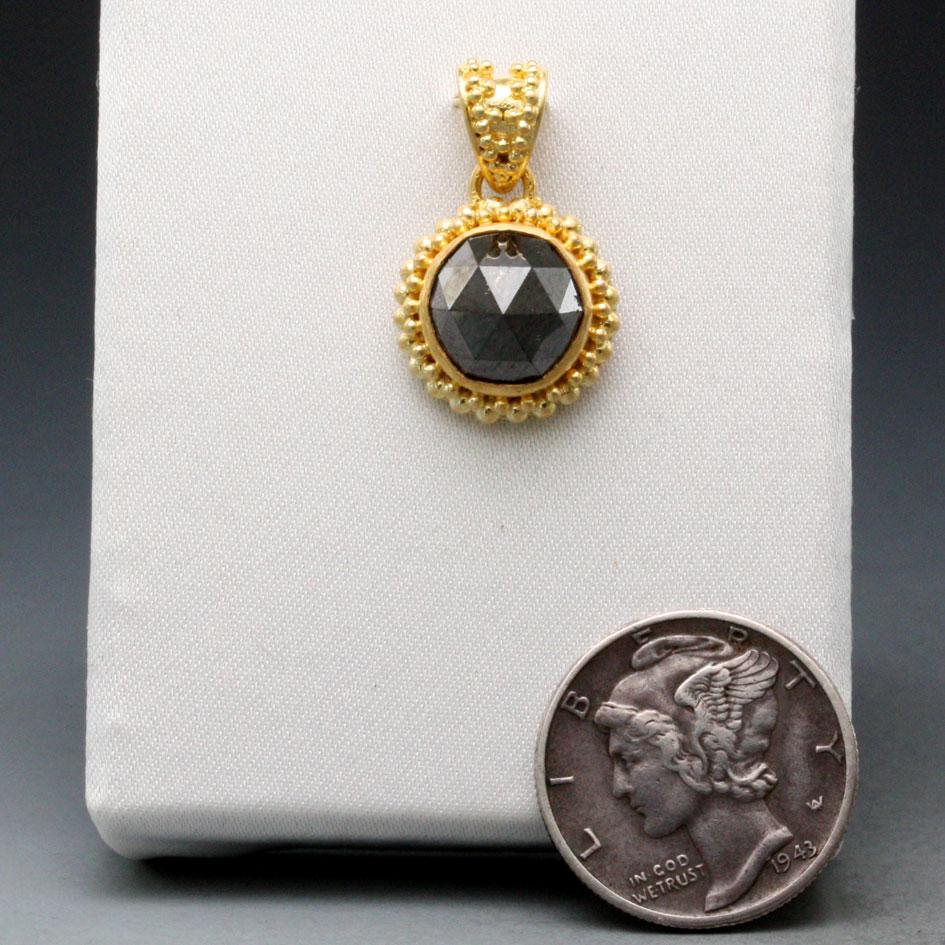 A beautifully lustrous 9 mm round rose cut faceted black diamond rests in a wonderfully contrasting stacked large/small 