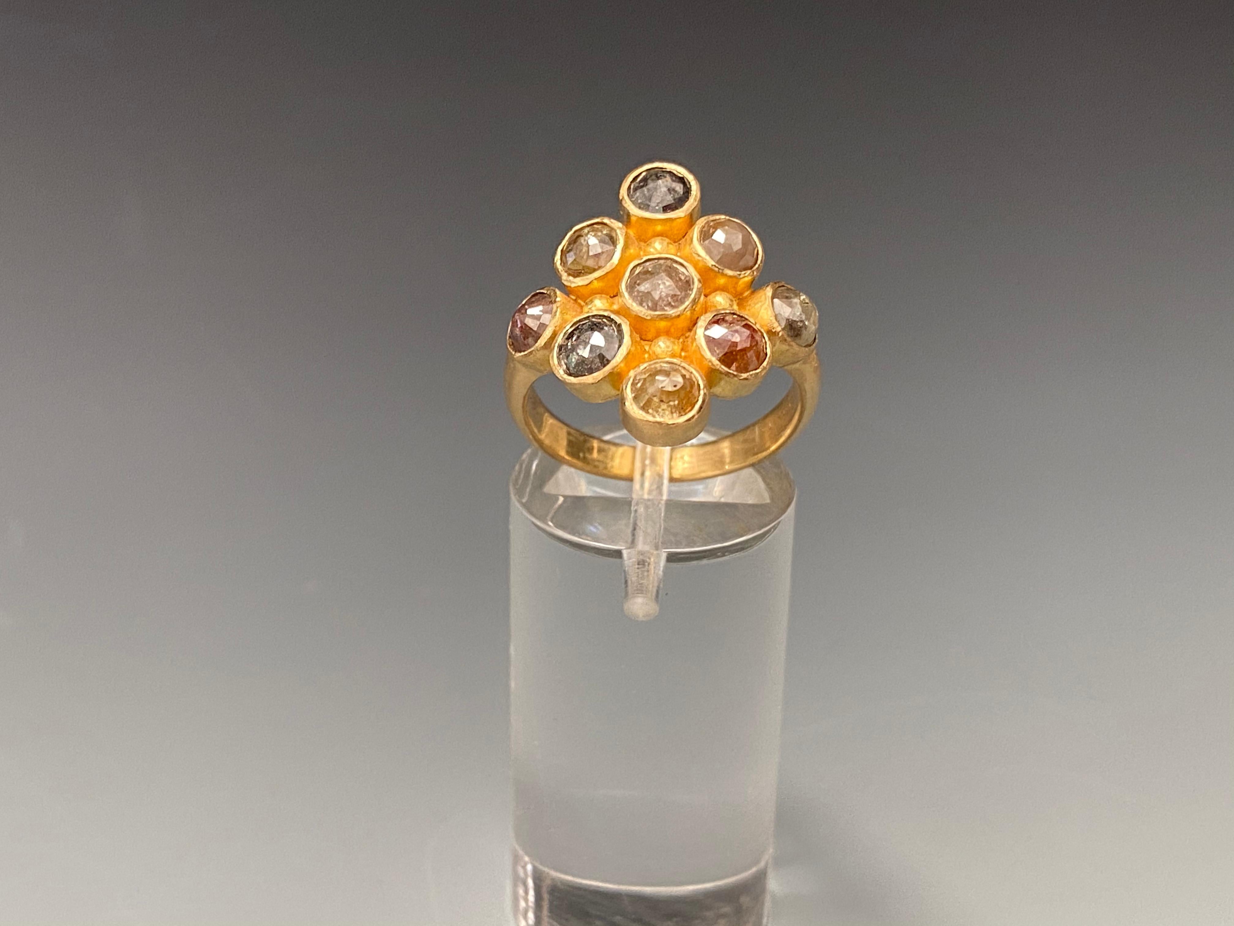 Nine 4mm multi-colored rough rose cut natural diamonds are held in simple bezels in a geometric Steven Battelle design with large 