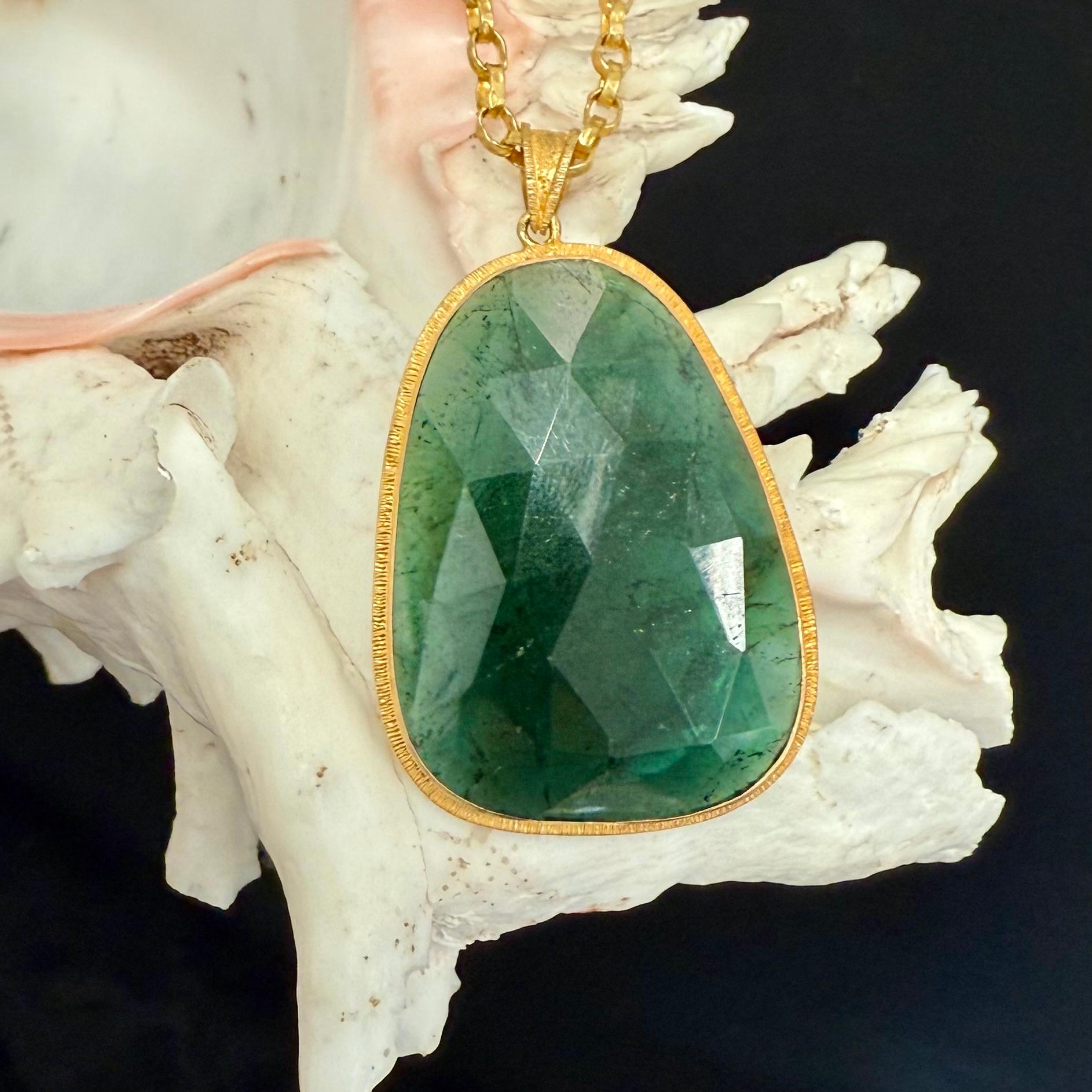An irregular large rose cut slice of Brazilian green tourmaline is set simply in an organic line texture setting.  A beautiful statement piece !  The chain shown is not included but can be ordered addtionally.

