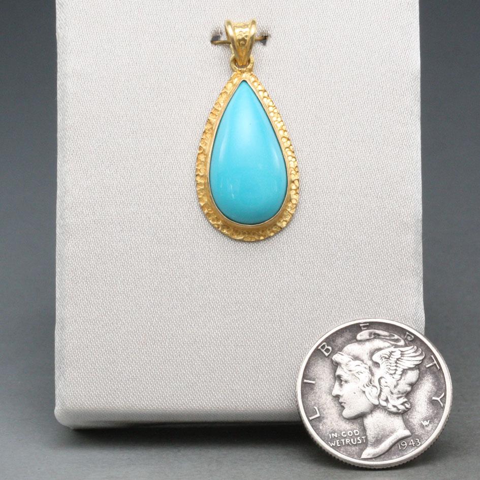 A top-grade Arizona Sleeping Beauty mine 9 x 17 mm pear shaped cabochon rests in a simple hand textured 18K double bezel setting in this elegant 18K gold pendant.  The 18K handmade hammered chain shown is not included, but can be ordered