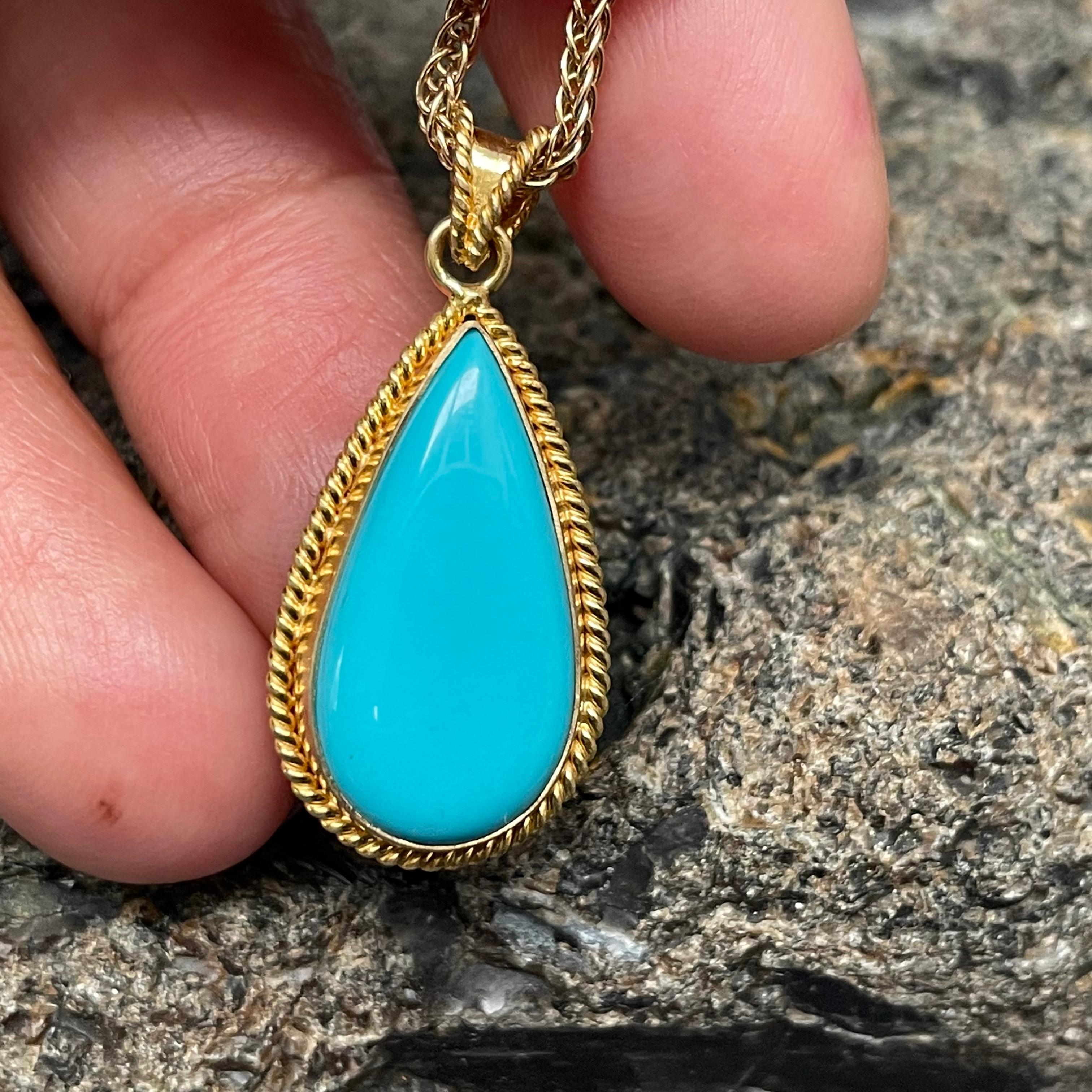 A perfect 11 x 21 mm pear shaped Arizona Sleeping Beauty mine turquoise cabochon is held in a classic handmade 18K gold twist wire bezel in this elegant design. The 18K woven triple spiga chain shown is included, in a 20