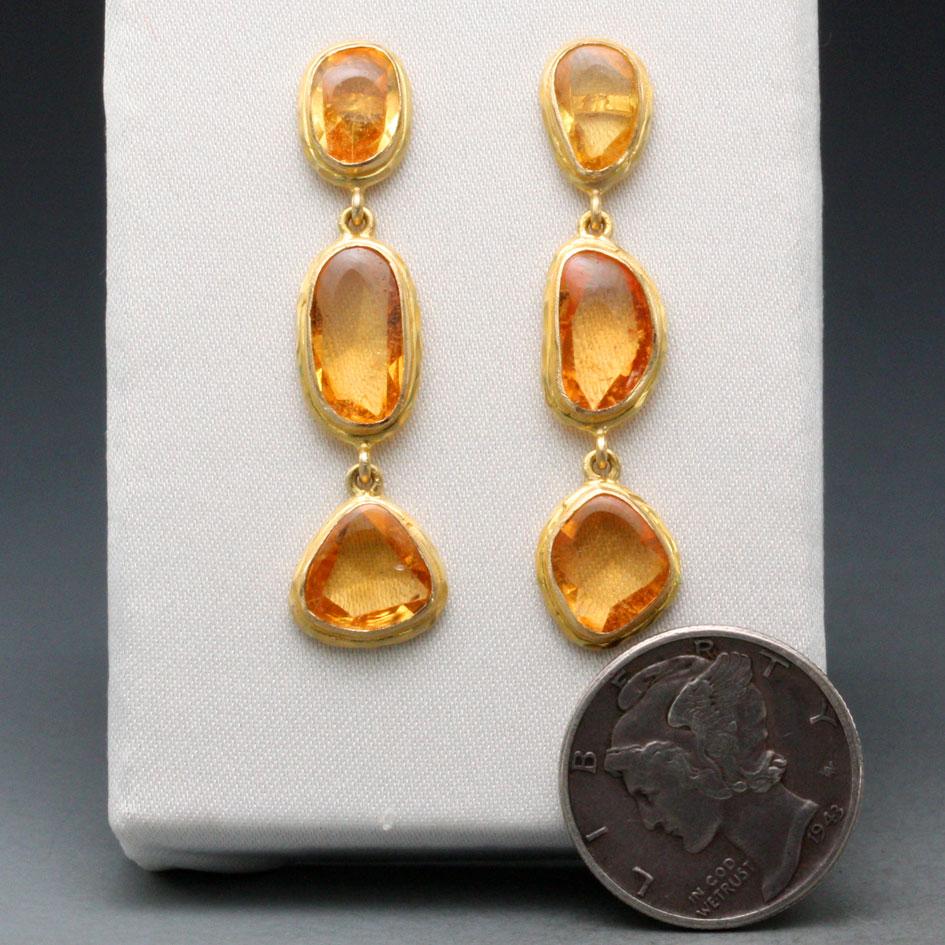 Rich and lively irregular shaped buff-top yellow sapphire stones are surrounded by hammered bezels in this unique Steven Battelle creation.  Beautiful !