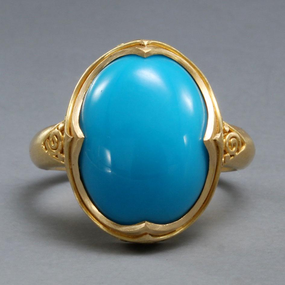A flawless 12 x 16 mm oval Arizona Sleeping Beauty mine turquoise rests in a medieval-inspired 