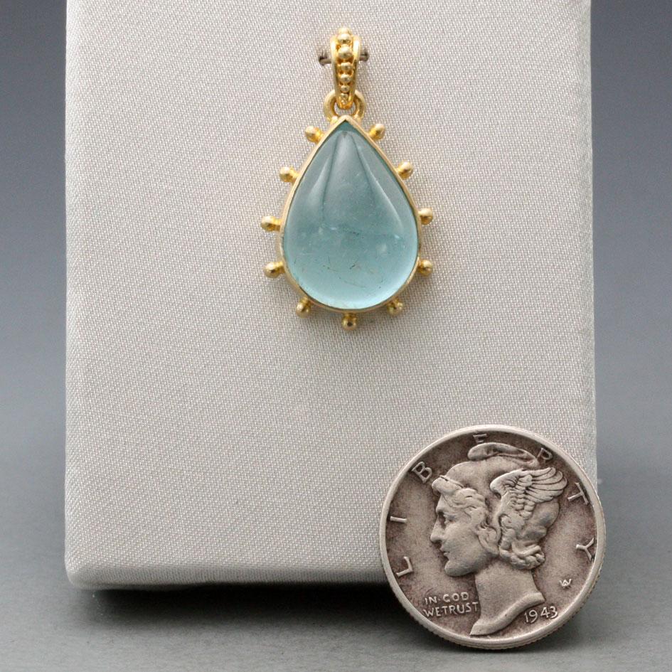A nice translucent Brazilian 11 x 15 mm pear shaped aquamarine cabochon is held in a simple bezel with multiple 