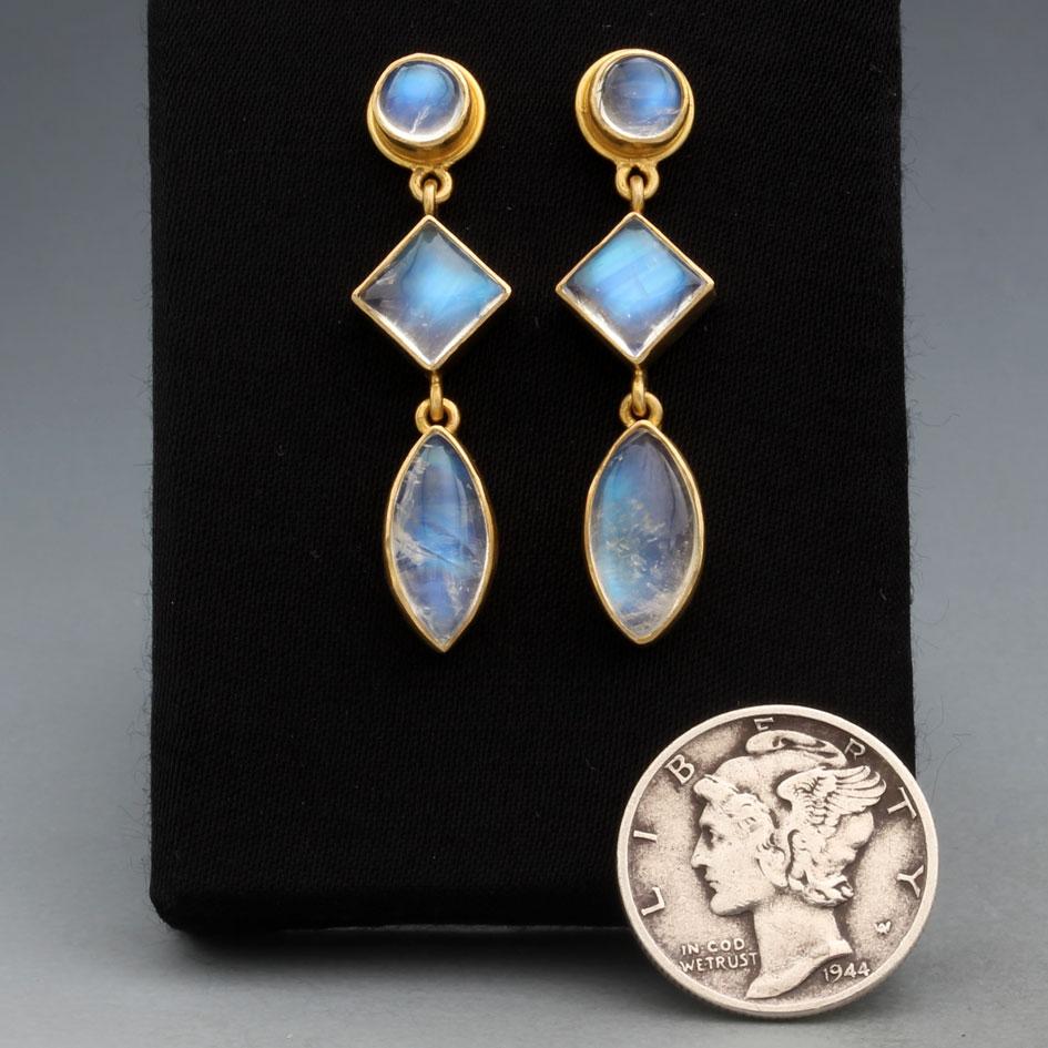 An interesting juxtaposition of round (5 mm) , square (6 mm), and marquis shaped (6 x 12mm) blue shimmering rainbow moonstone cabochons make a beautiful combination for a post earring design.  The 5mm round posts are surrounded by matte-finish gold