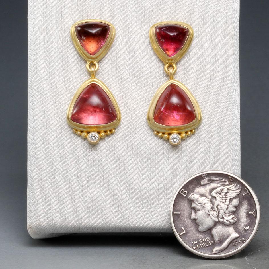 Opposing trillium pink tourmaline cabochons of 7 and 9 mm delight in these beautiful and well balanced post earrings surrounded by wide matte-finish gold borders. The larger stones below are ornamented with graduated 