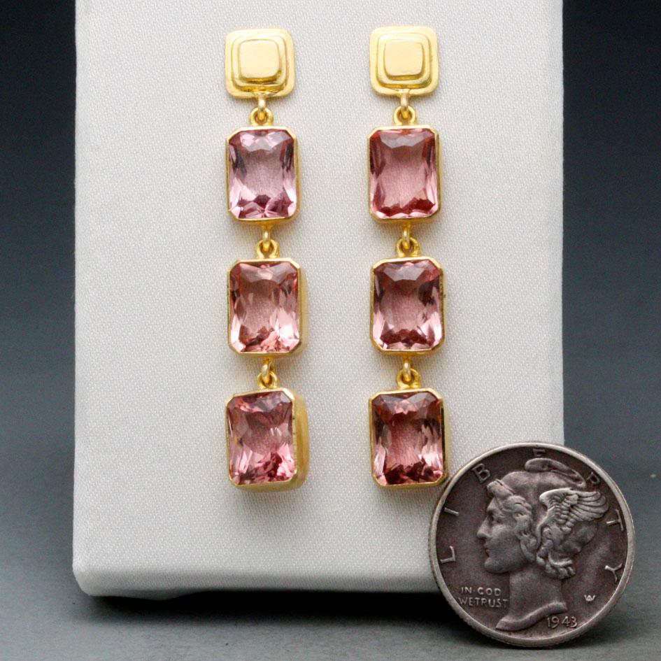 Light and airy Brazilian pink tourmaline faceted 6x8 mm octagons dangle below stepped 18K posts in this Steven Battelle design. These beautiful stones are lively and attractive. 
