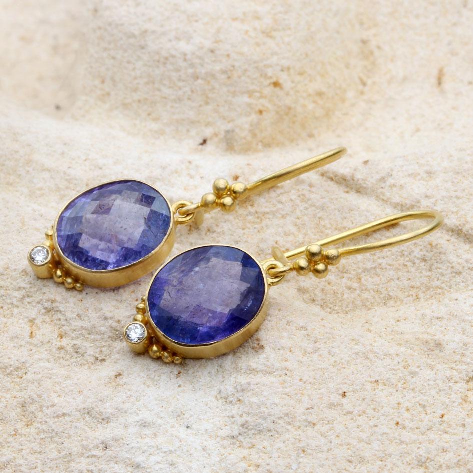 Two 9 x 11 mm rose-cut oval tanzanites are set in 18K gold matte-finish bezels with 1.9 mm VS1 diamonds accenting below.  Handset 