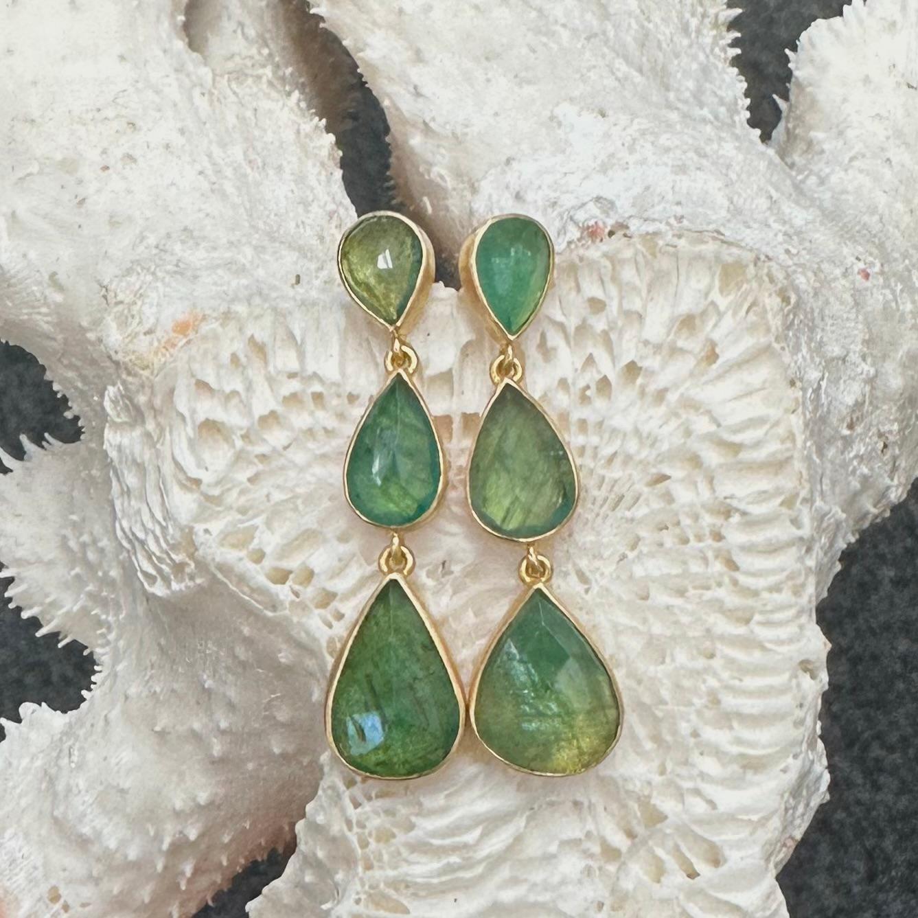 Six pear shaped rose faceted Zambian emeralds ranging in size from 6 x 8 mm to 9 x 14 mm are set in simple handcrafted matte-finish 18K gold bezels with the gold backs reflecting lots of light back though the stones.  Sometimes there is nothing that