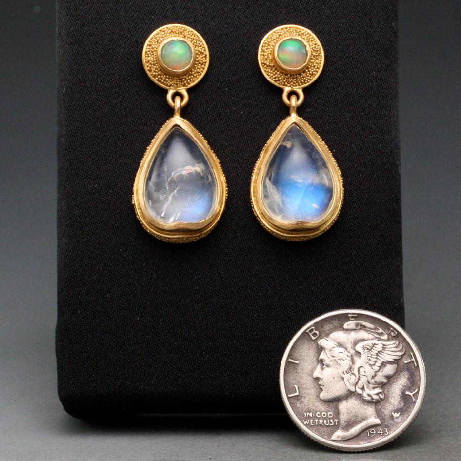 Two  8 x 12 mm pear shaped blue sheen rainbow moonstones dangle below 4 mm greenish Ethiopian 