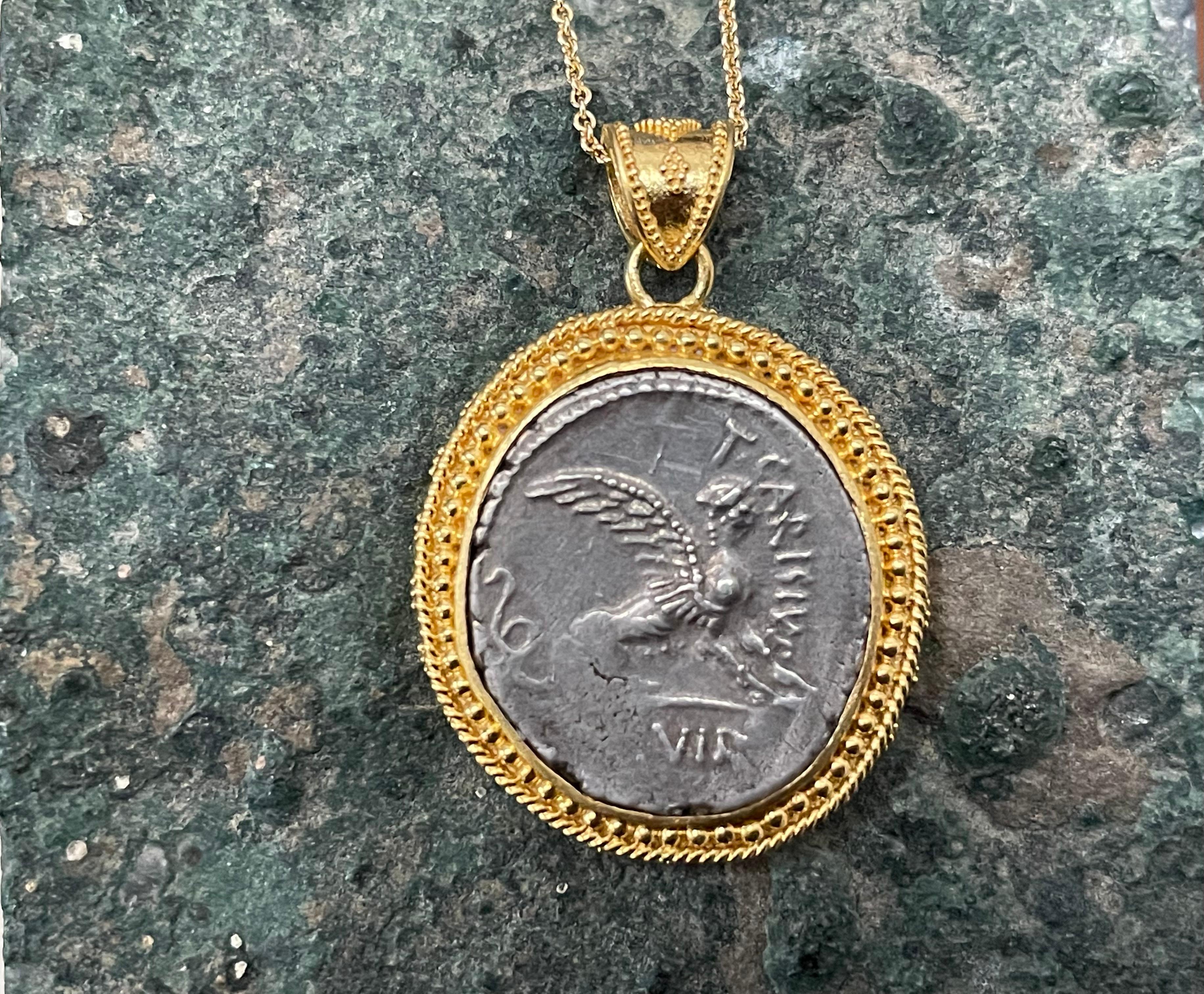 A rare and seldom seen Roman Republican Denarius from 46 BC featuring an Egyptian Sphinx is displayed in an exquisitely granulated Steven Battelle designed setting created by a master goldsmith.  

The Romans were awed by the Egyptian monuments and