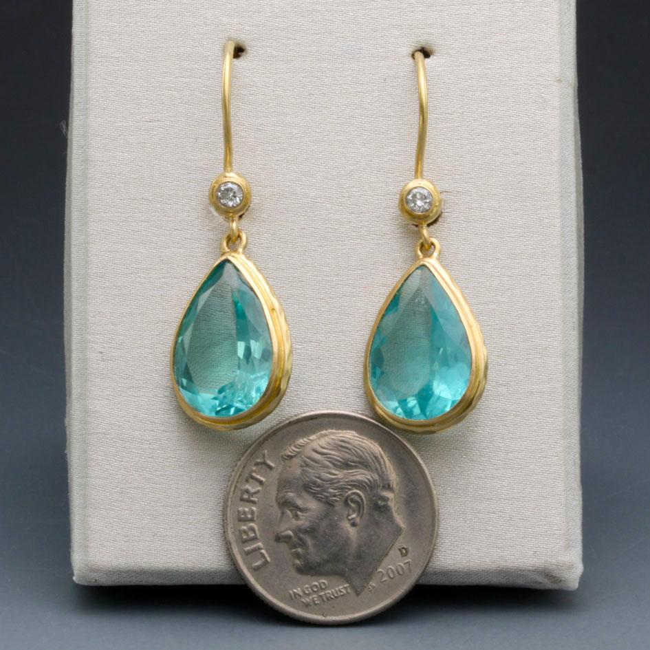 Simply beautiful 7 x 10 mm faceted pear shaped Apatites are set in simple matte-finish bezels and dangle below 1.8 mm VS1 diamonds in similar settings.  Apatite (rare in this size) is thought to expand knowledge and truth and eases sorrow, apathy,