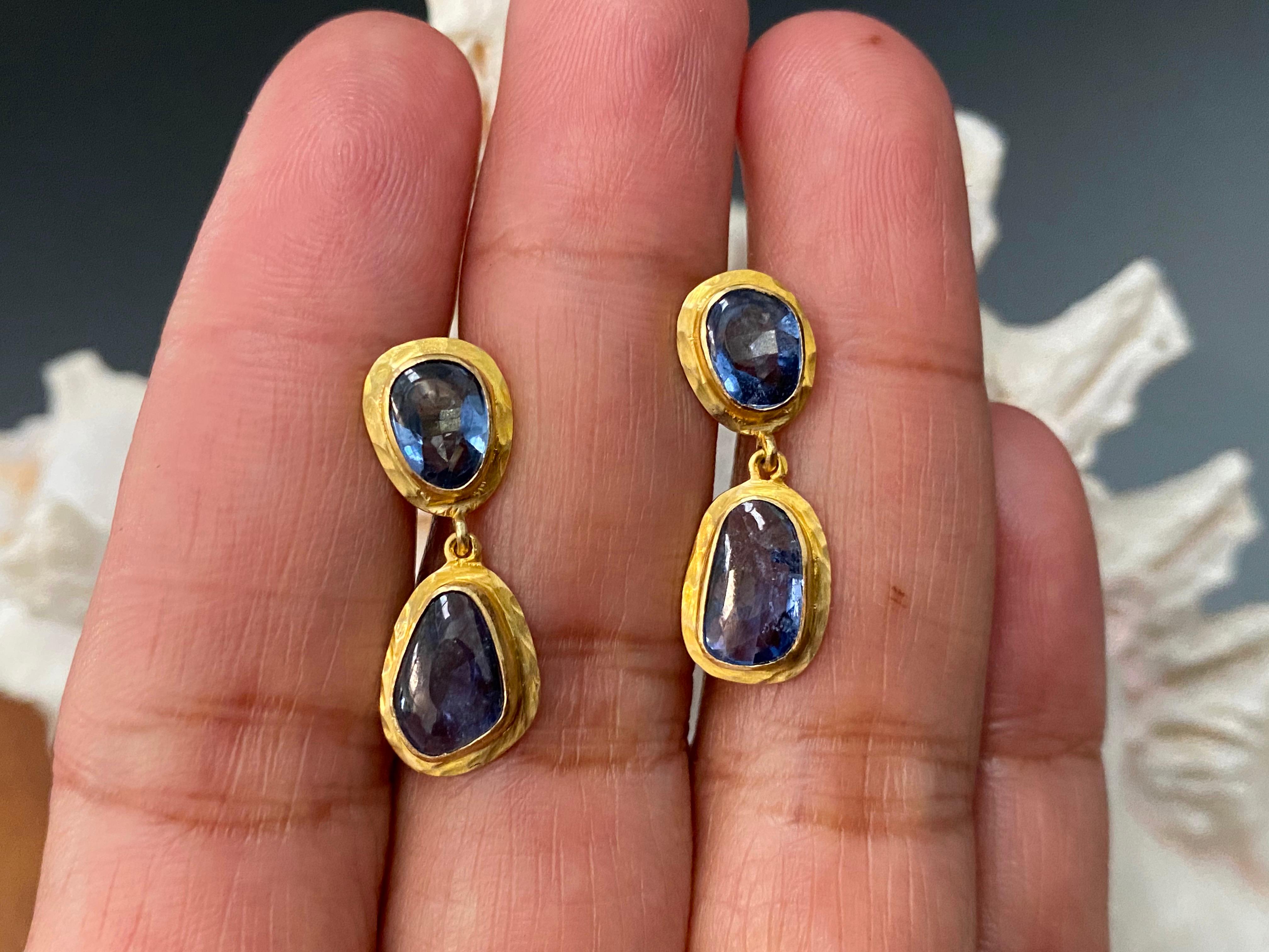 Four mixed organic shape buff top Blue Sapphires are combined into a simple handcrafted hammered bezel setting.  Subtle and fun.  4.7 Carats
Total Weight 3.78 gram
Length 25mm