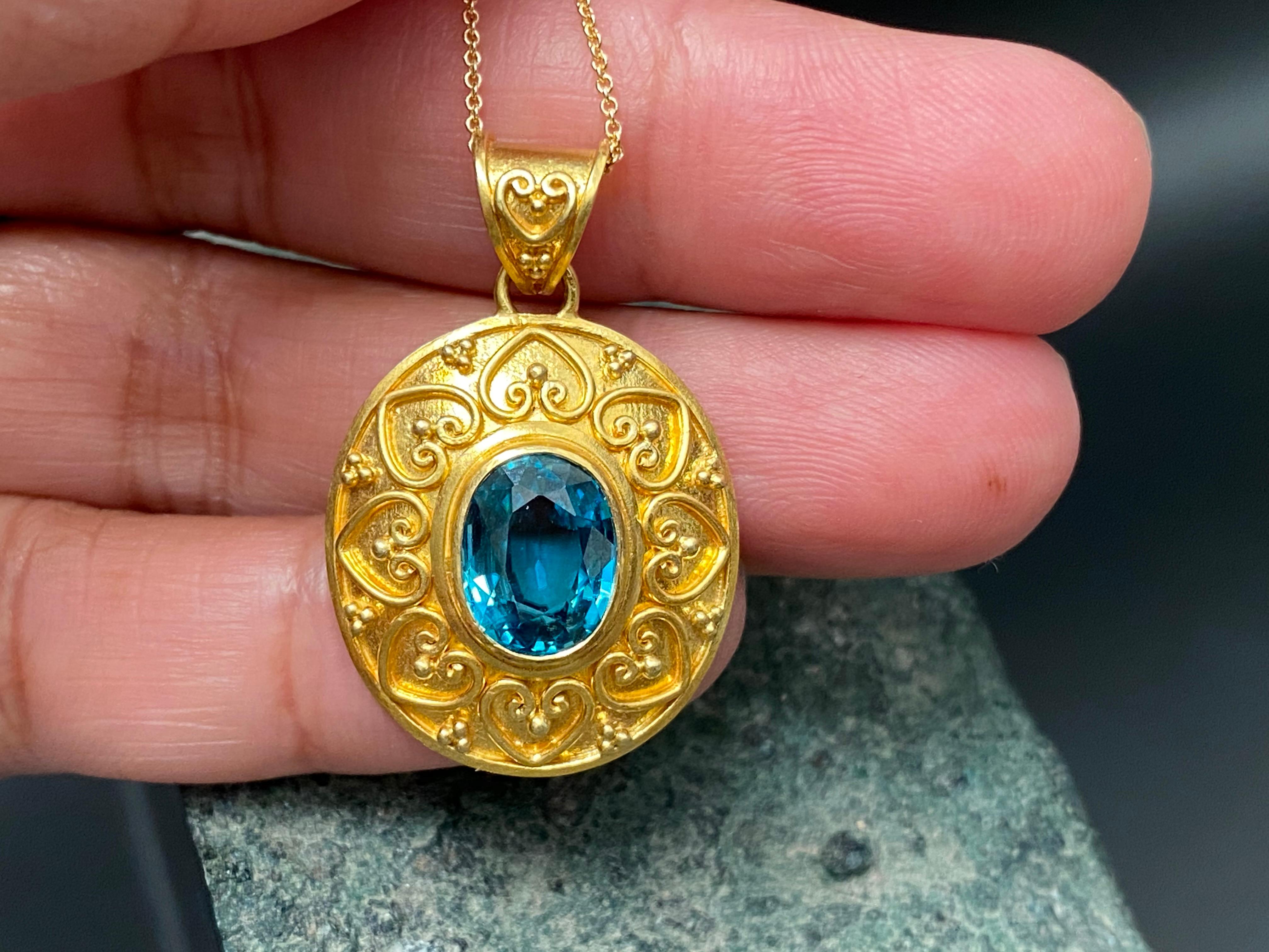 Beautiful handcrafted ornate 4.5 carat deep Blue Zircon pendant in Matt finish 22K.  Blue Zircon is sourced  from the Ratanakiri province of Cambodia, which means “Mountain of Gems” in Khmer, the local language.  This pendant is created by soldering