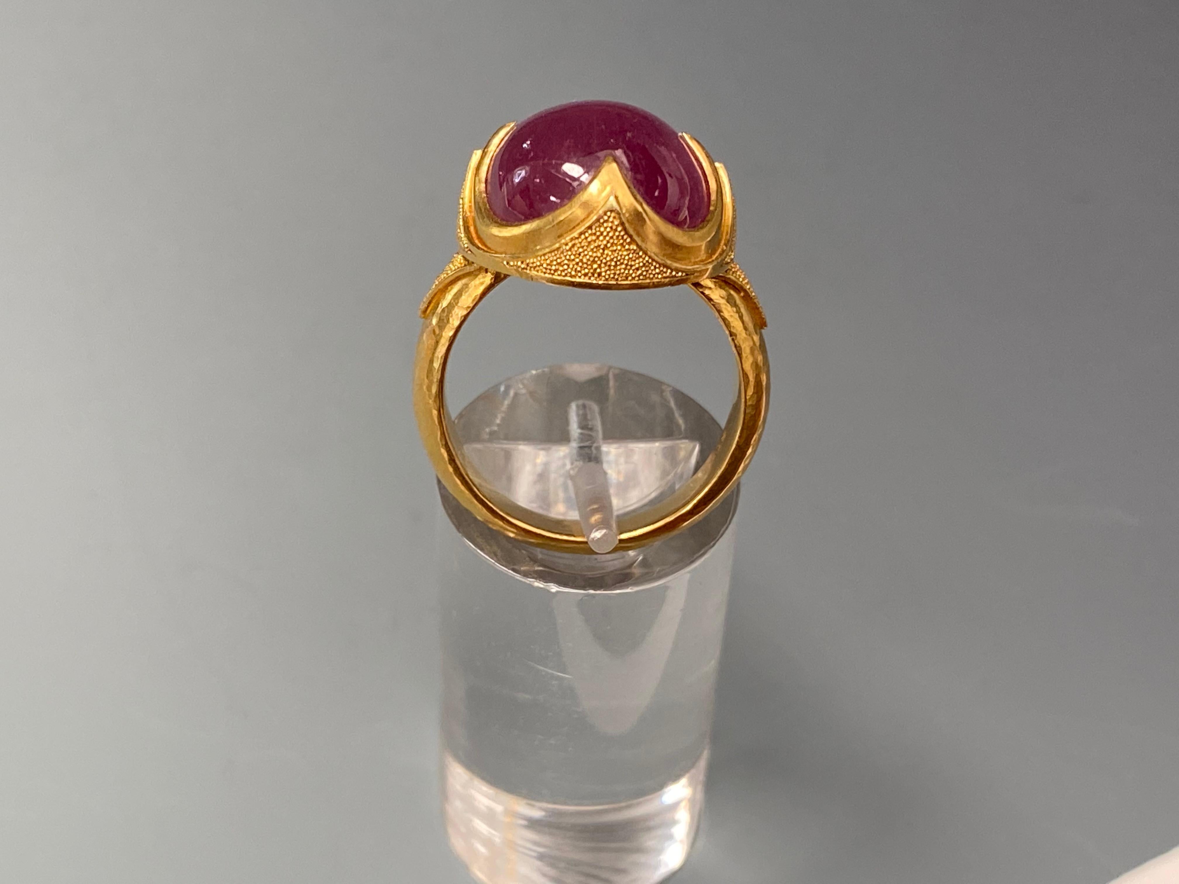 A gorgeous pink 22 Carat 12x16 mm cabochon Ruby is held in a 4 point classic design with fine gold 