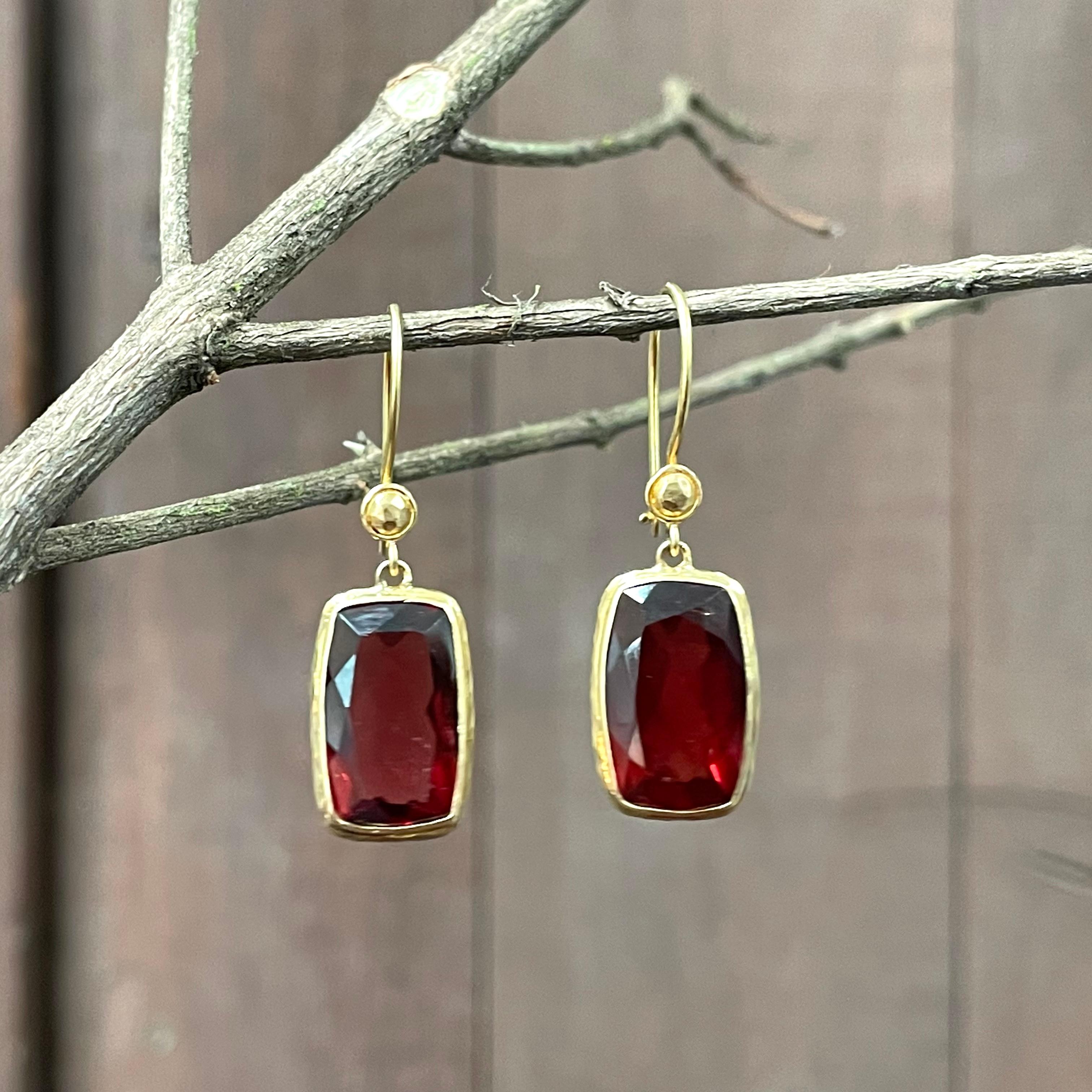 A pair of 8 x 14 mm long cushion shaped Mozambique garnets is suspended below round wire bottoms and surrounded by a slightly hammered bezels.  These are nice stones that have a lot of color and are not dark. Safety clasp wires complete. Elegant!