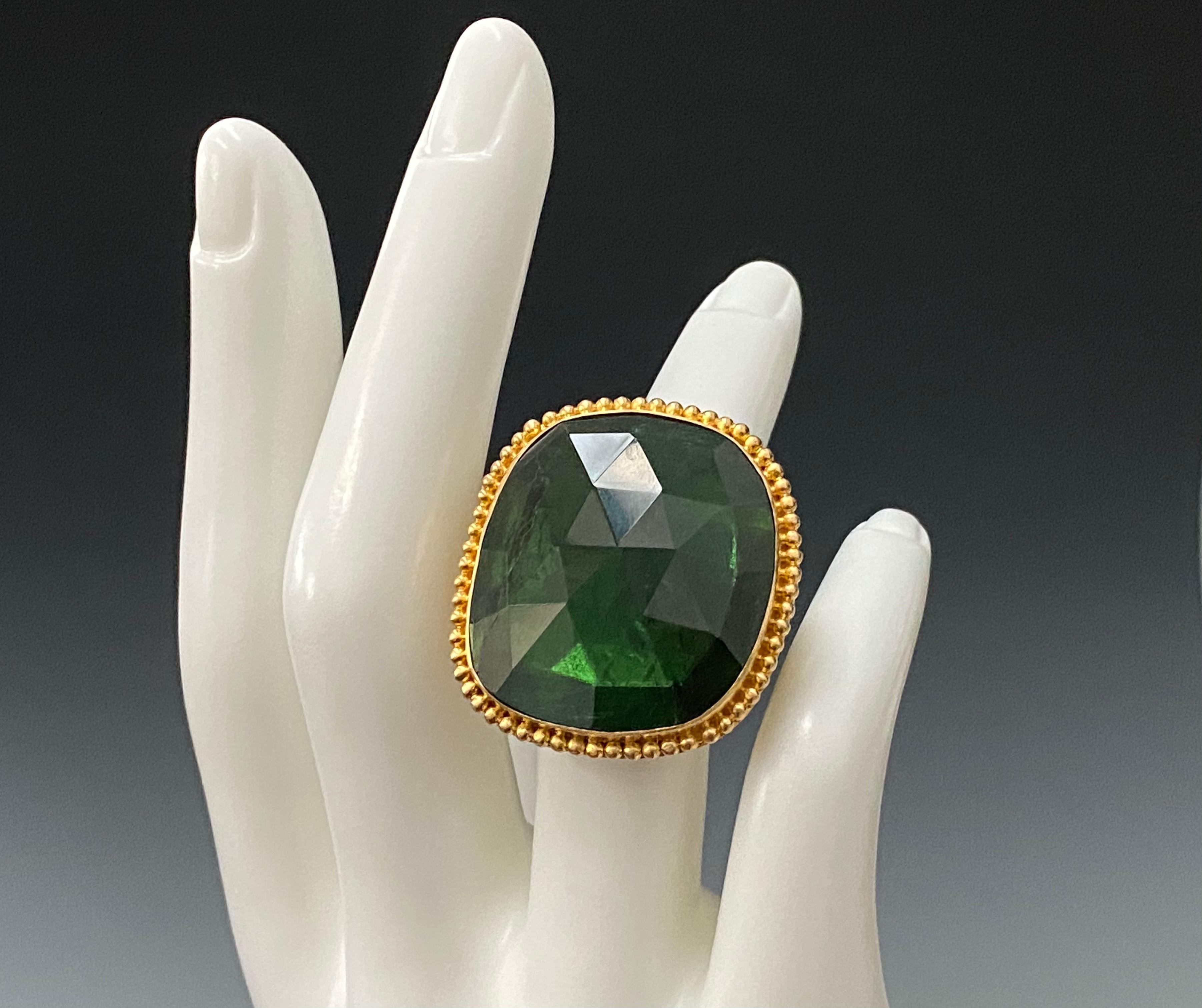 A large 26 x 28 mm irregular rose-cut Brazilian green tourmaline slice is surrounded by large granulated 