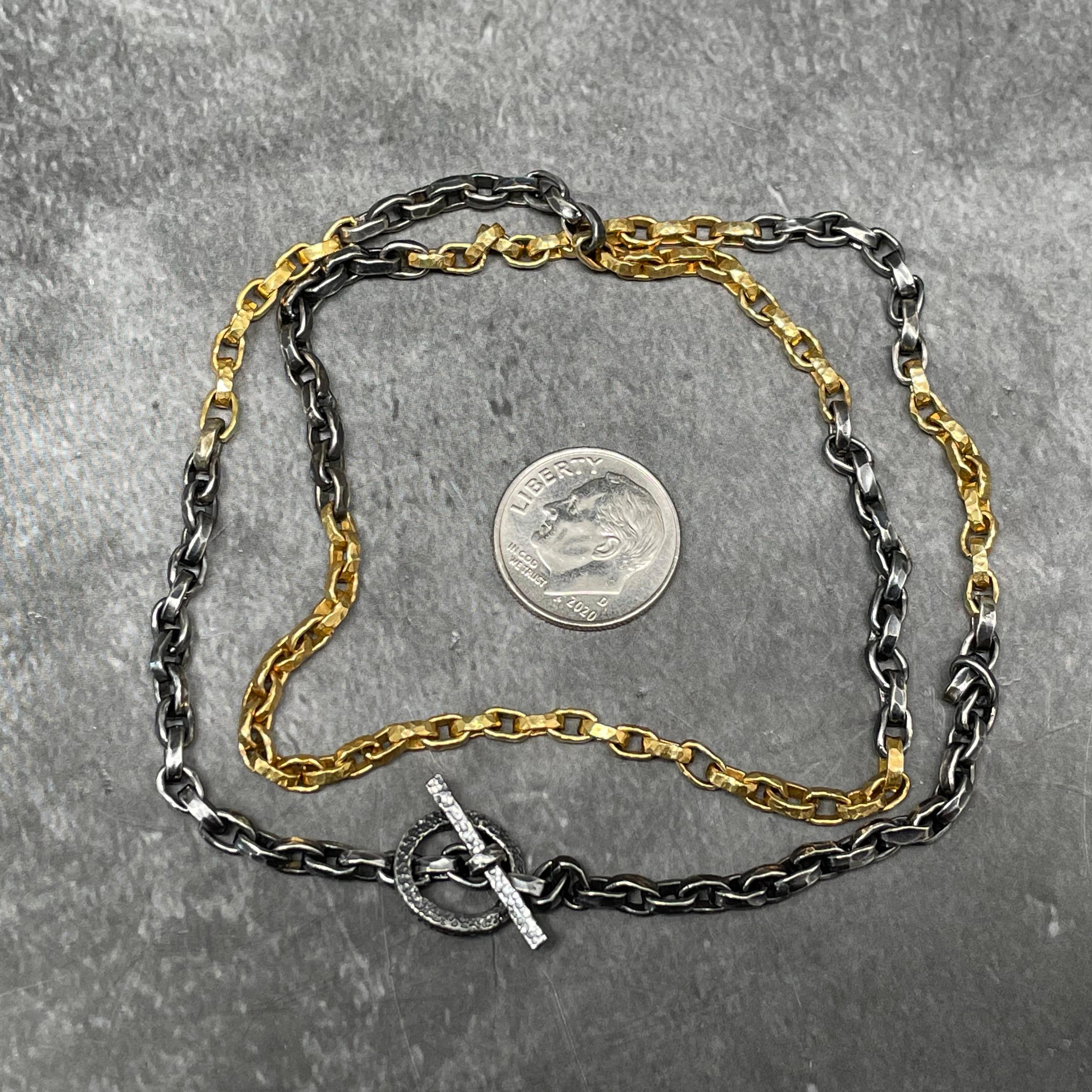 A handmade chain with organic hammered links of alternating 18K yellow gold and dark oxidized silver is a beautiful piece all by itself, or used with a pendant.  The links are approximately 1.5mm wide. There are 32 gold links at the bottom, with 12,