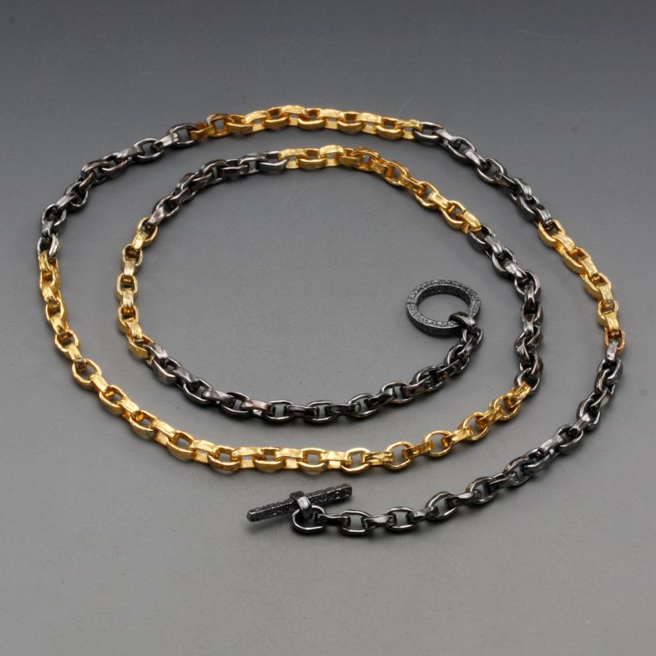 A handmade chain with organic hammered links of alternating 18K yellow gold and dark oxidized silver is a beautiful piece all by itself, or great with a pendant.  The links are approximately 1.5mm wide. There are 32 gold links at the bottom, with