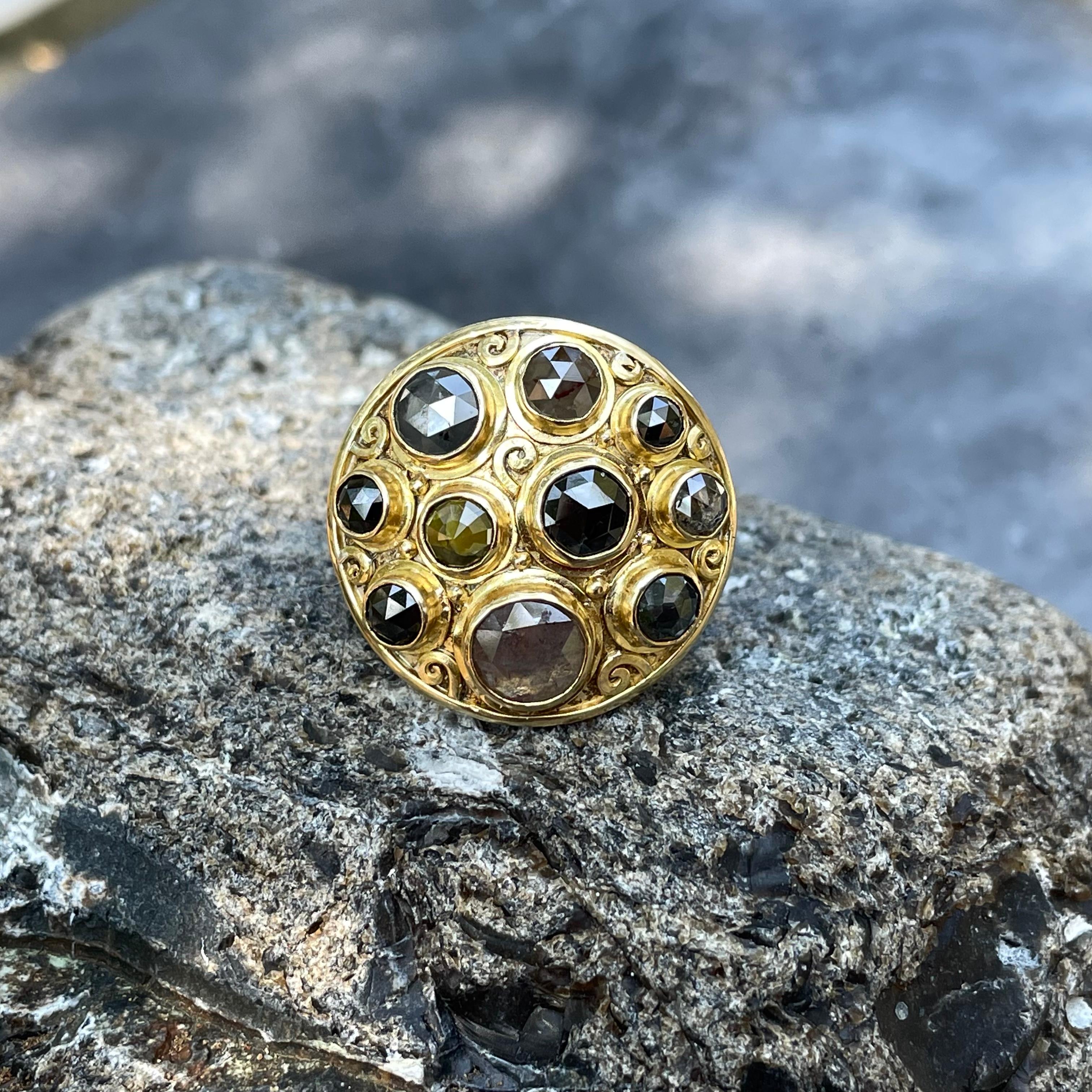 An interesting assortment of 10 multicolored rose cut rough round diamonds in assorted sizes from 7 to 3 mm are displayed in a circular pattern, with small spiral accents dispersed among them in this Steven Battelle designed piece.  4.9 Carats