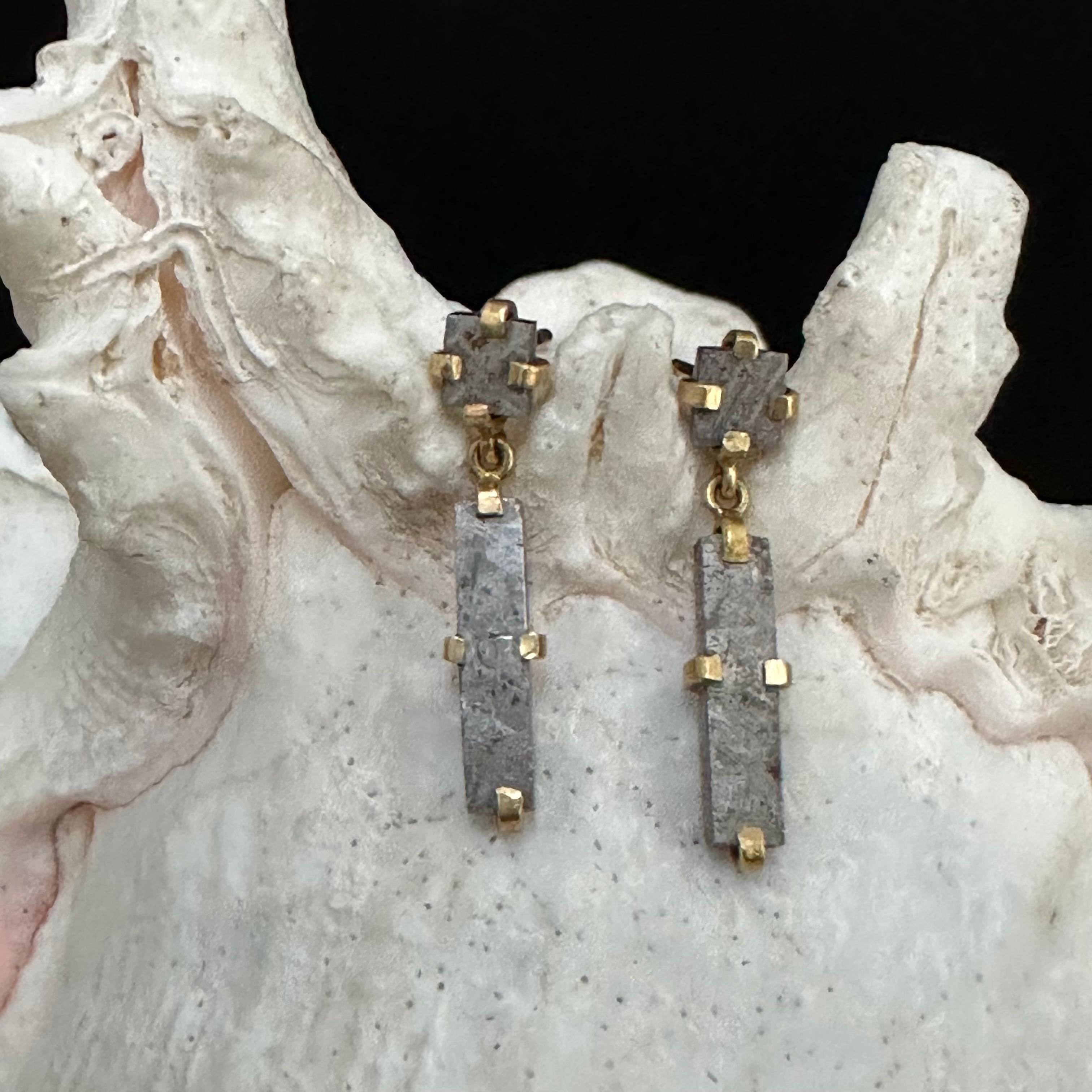 5 mm square and 5 x 20 mm rectangular cut slices of Gibeon meteorite are set within 18K gold clasps to create this interesting and unique post earring design.  The Gibeon meteorite(s) fell in prehistoric times in Namibia and was a huge event