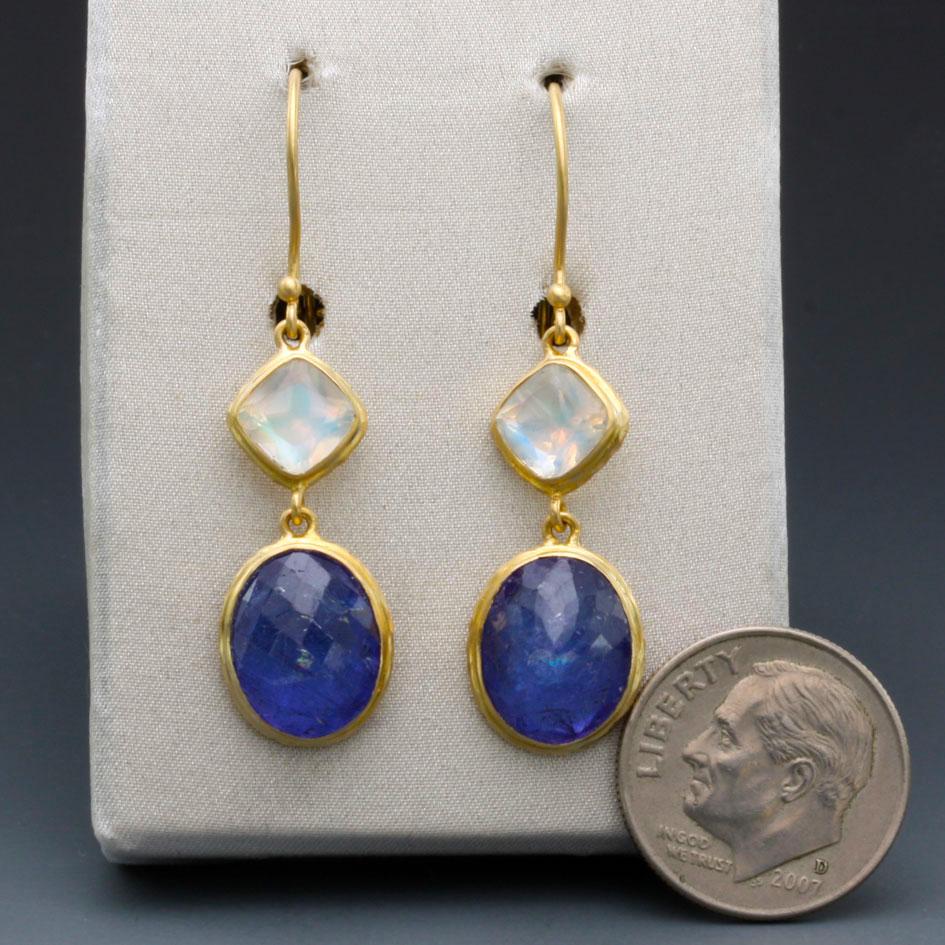 Marvelous rose cut Tanzanite ovals dangle from cushion faceted Rainbow Moonstones with hammered bezel accents on safety wires.
10.3 carats total stone weight. Stunning complementary stone colors!
