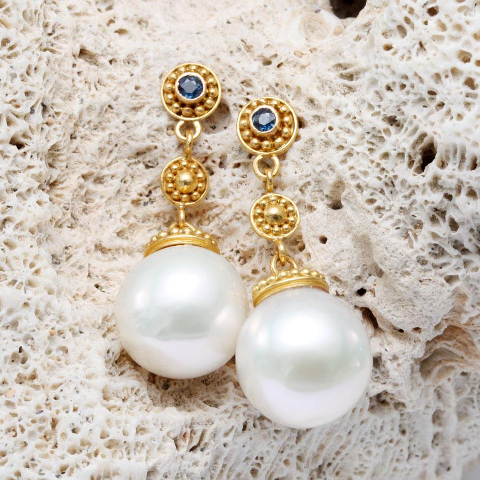 Two lustrous 13mm round freshwater white pearls dangle on handmade granulated caps below similarly decorated components and granulated posts with 3 mm inset faceted blue sapphires. A popular style for us. You won't be disappointed!

