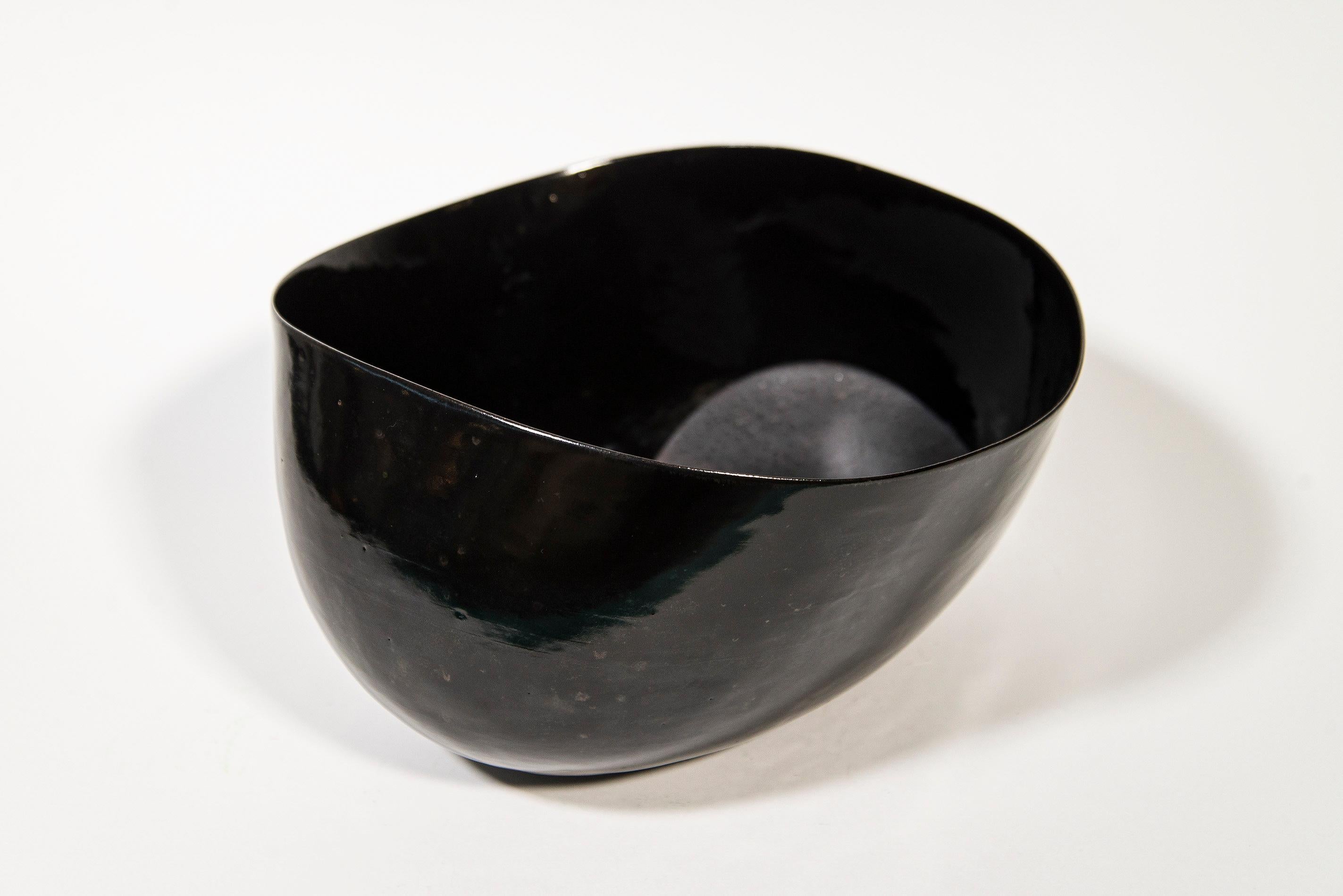 Canadian artist Steven Heinemann continues to re-define the limits of ceramic art with a new series of uniquely beautiful bowls called ‘Afterlife.’ This oval-shaped ceramic bowl has a glossy black exterior finish, and the interior is textured in a