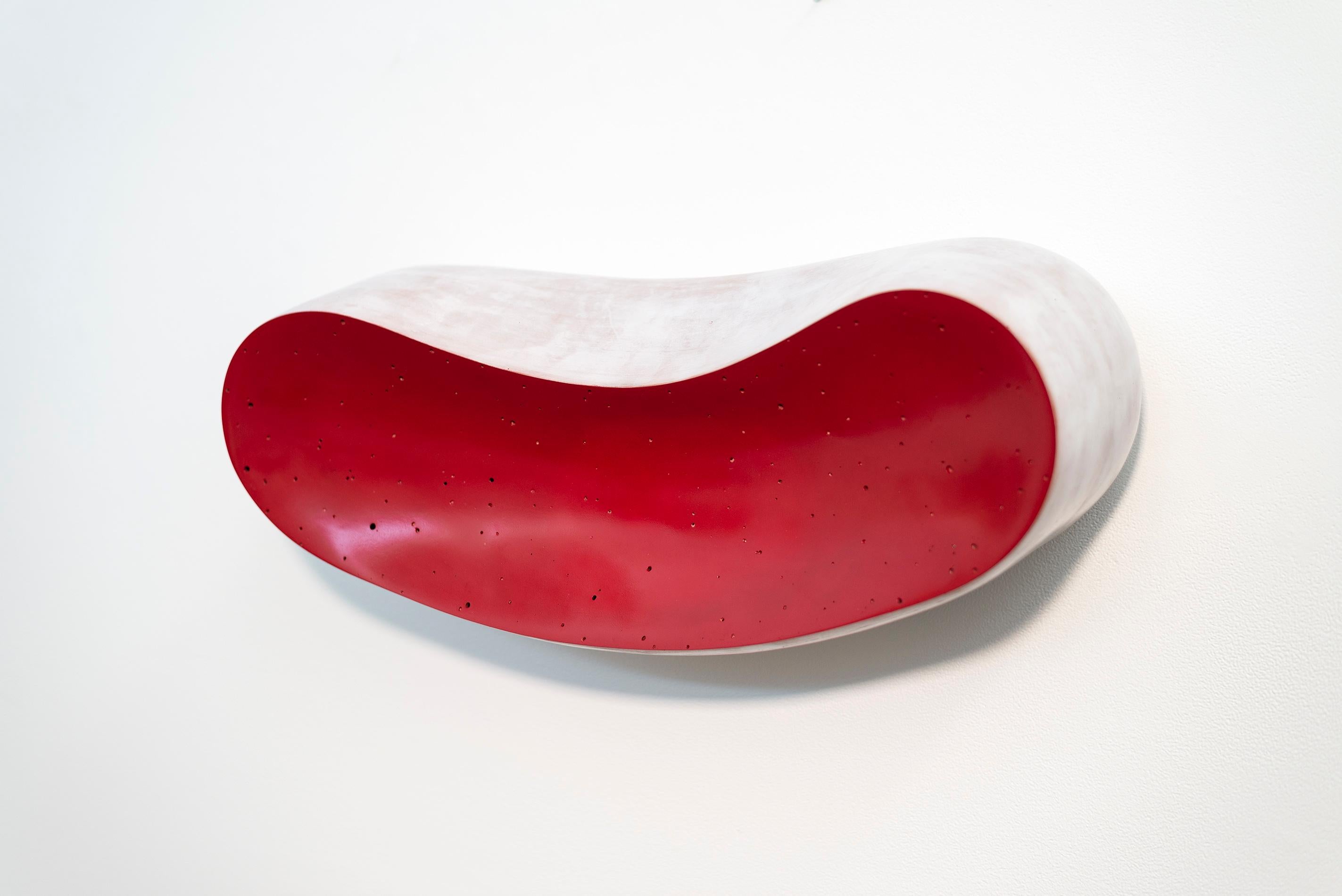 It is a striking piece. Steven Heinemann’s wall mounted ceramic sculpture has a bold fluid organic form and equally bold colour—deep red. Called “La Bouche” which means mouth in French, the shape of this ceramic piece resembles a mouth, wrapped in