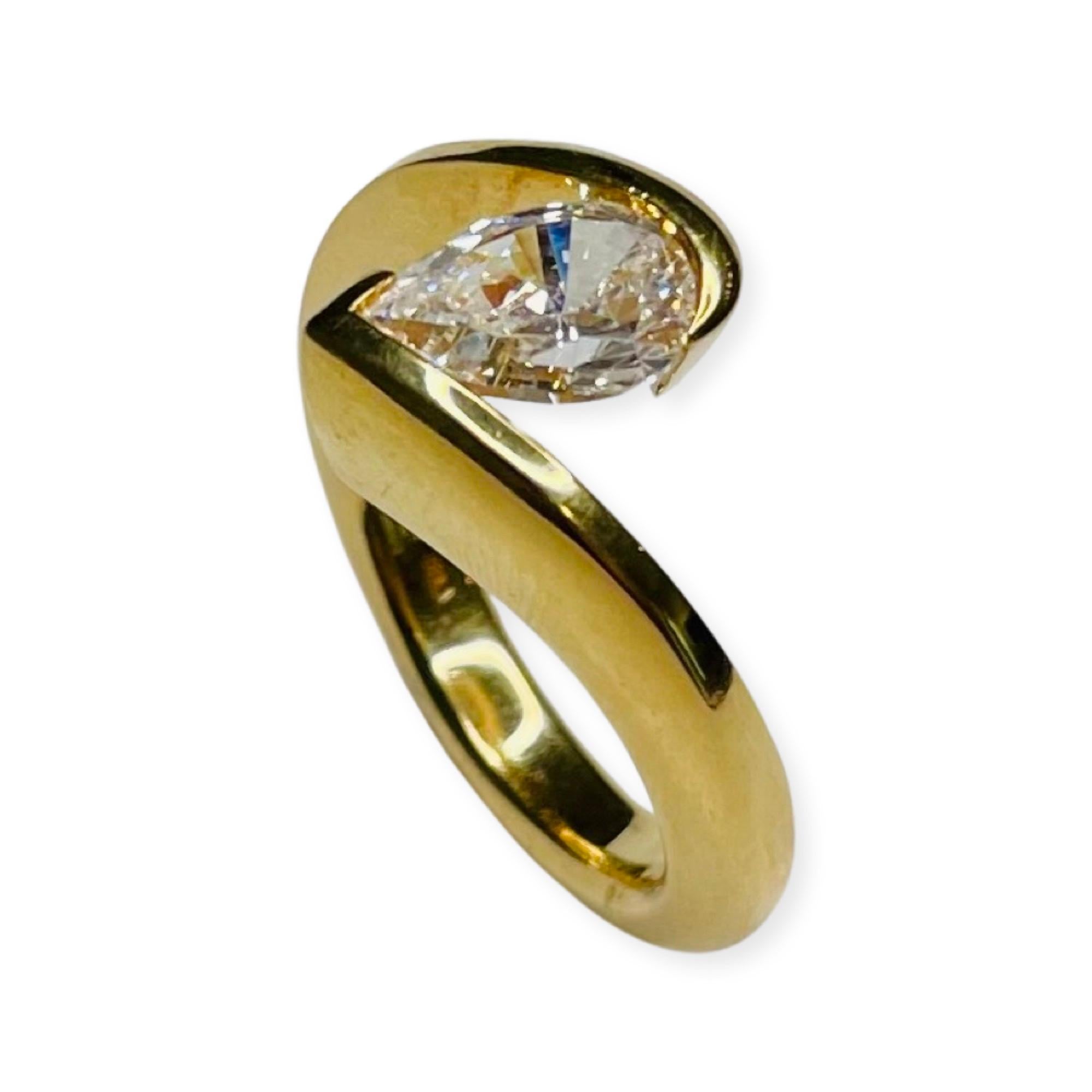 Steven Kretchmer 18K Yellow Pear Shaped CZ Tension Set Ring. The ring is designed to hold a 1.5 carat diamond.  It is Hallmarked Pt950 c 1990 USA.  It is trademarked with the triangle with comet tails off of the points for Kretchmer. It is ring