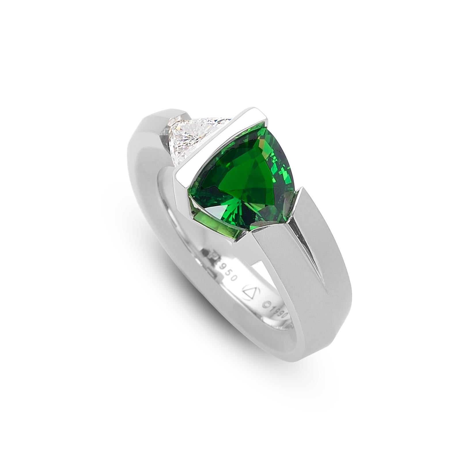The Steven Kretchmer 2-Stone Rudder ring with a tension-set trillion cut diamond and chrome tourmaline is handcrafted in platinum with a half matte finish. The 0.55 ct. trillion cut diamond is VS with F-G color. The 2.02 ct. trillion cut chrome