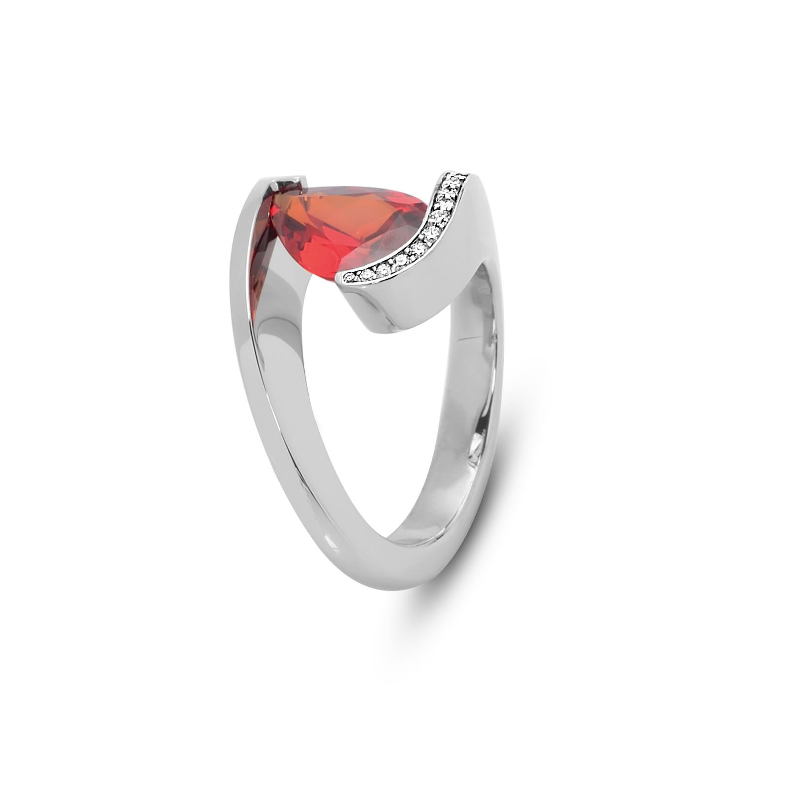The Steven Kretchmer DP Ring with a tension-set orange sapphire is handcrafted in platinum with a shiny finish. The 2.91 ct. pear shaped sapphire is a vibrant, fiery orange color, beryllium treated and comes with a GIA certificate.  The top of the