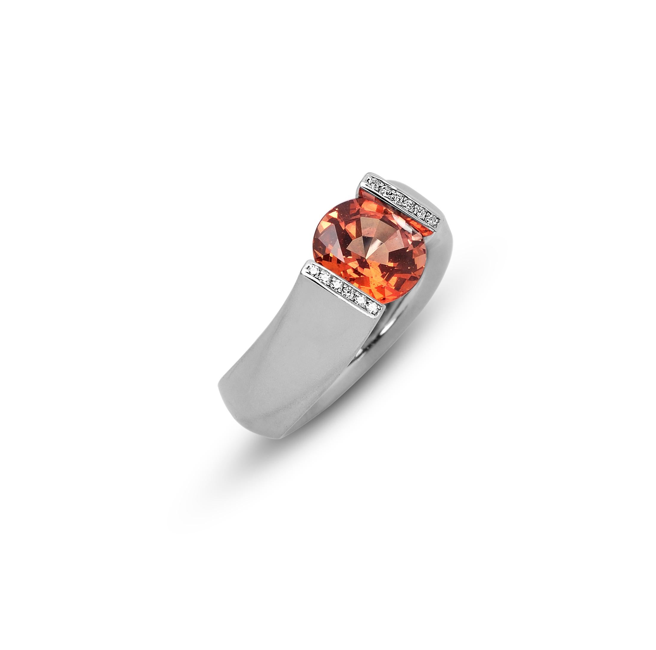 The Steven Kretchmer Fancy Figure 8 (FF8) Ring with a tension-set orange sapphire is handcrafted in platinum with a matte finish. The 2.68 ct. round cut sapphire is a vibrant, fiery orange color (beryllium treated).  The 