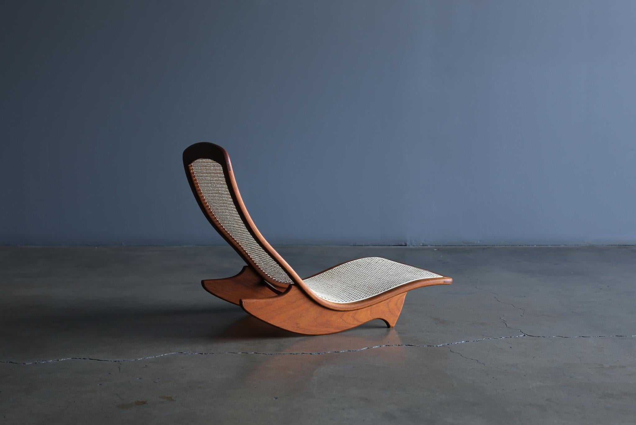 Handcrafted low rocker in teak and cane by California Artist, Steven Rieman. The design was exhibited at the Pasadena Museum of Art as part of the seminal California Design 76. Rieman was a graduate of the prestigious ArtCenter College and moved to
