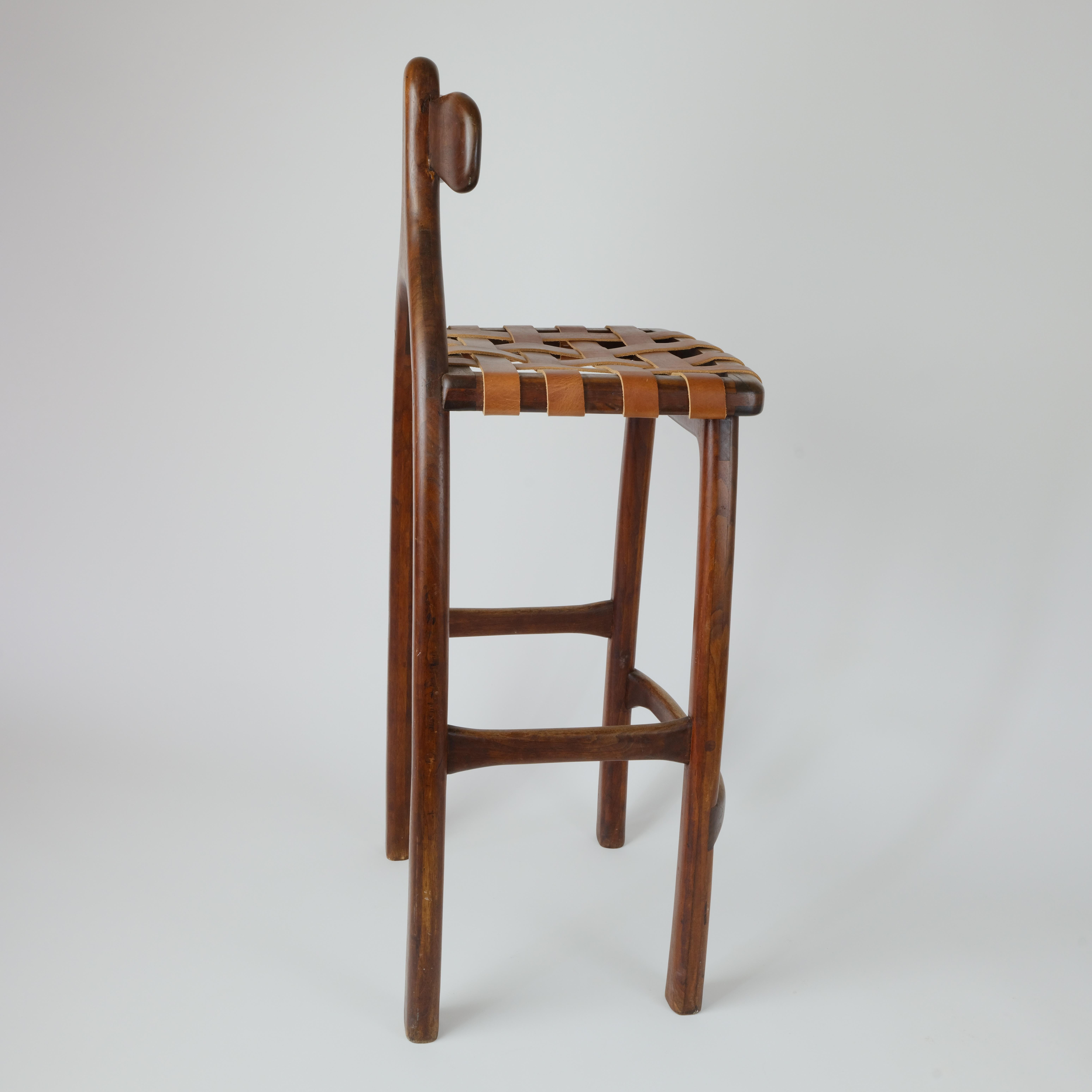 Steven Spiro Wisconsin based studio wood worker also noted Buddhist Chaplin.

This is a bar height stool hand hewn sanded finish with leather strap seat.
Condition of this piece is great no issues what soever, although the leather seems to be new.

