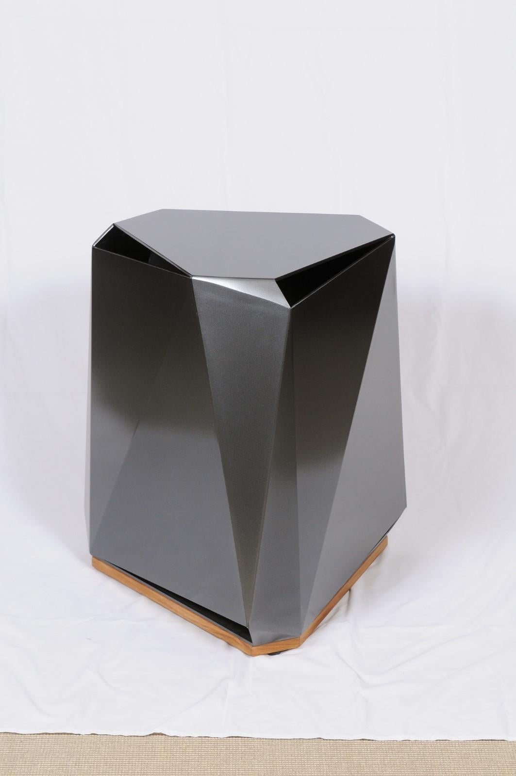 The Steven Volpe Coburg faceted side table is modern in design and material, and provides a strong counterpoint to the other pieces of The Steven Volpe collection. Pushing the boundaries of plate aluminum bending, the metal multifaceted table is