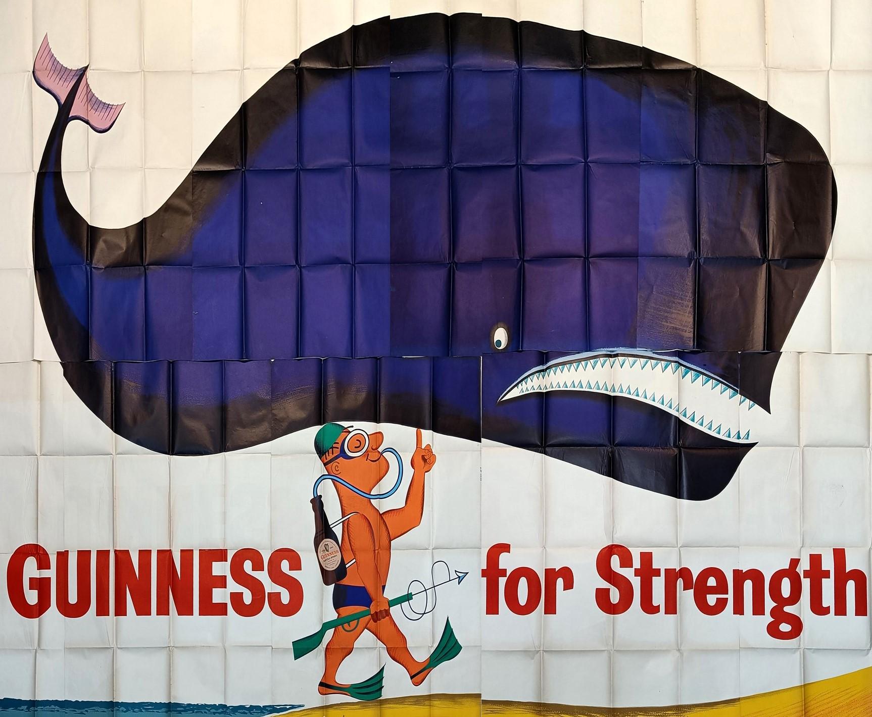 Rare billboard size original vintage Guinness advertising poster - Guinness for Strength - featuring fun mid-century modern image of a scuba diver with a Guinness bottle as his dive tank holding a blue whale on one finger, the text in bold red