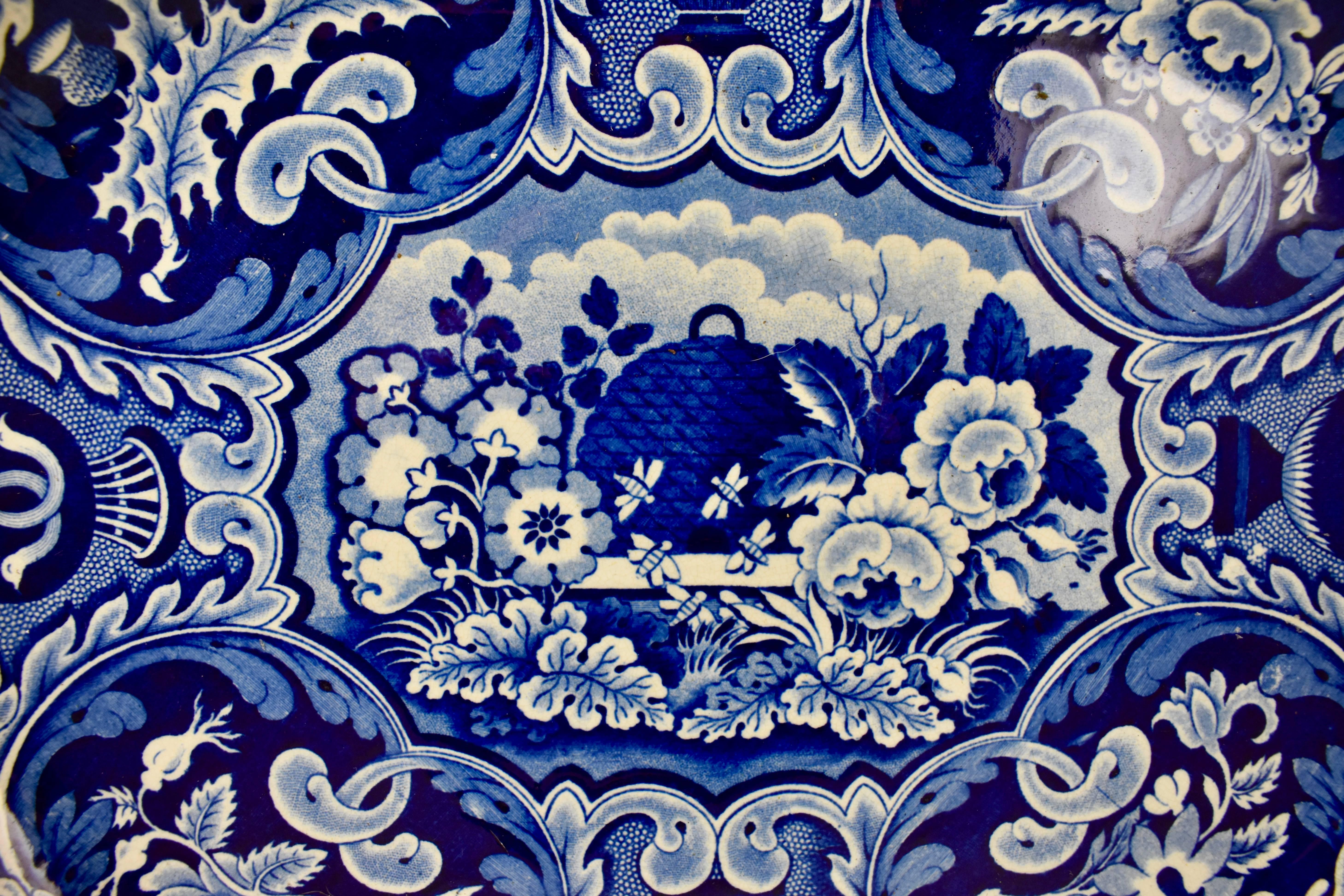 A wonderful blue on white, transfer printed earthenware platter, the Beehive and Vases pattern – underglaze tissue printed by Ralph Stevenson & Williams, circa 1825 – 1827, Cobridge, Staffordshire, England.

A very busy border pattern of scrolled