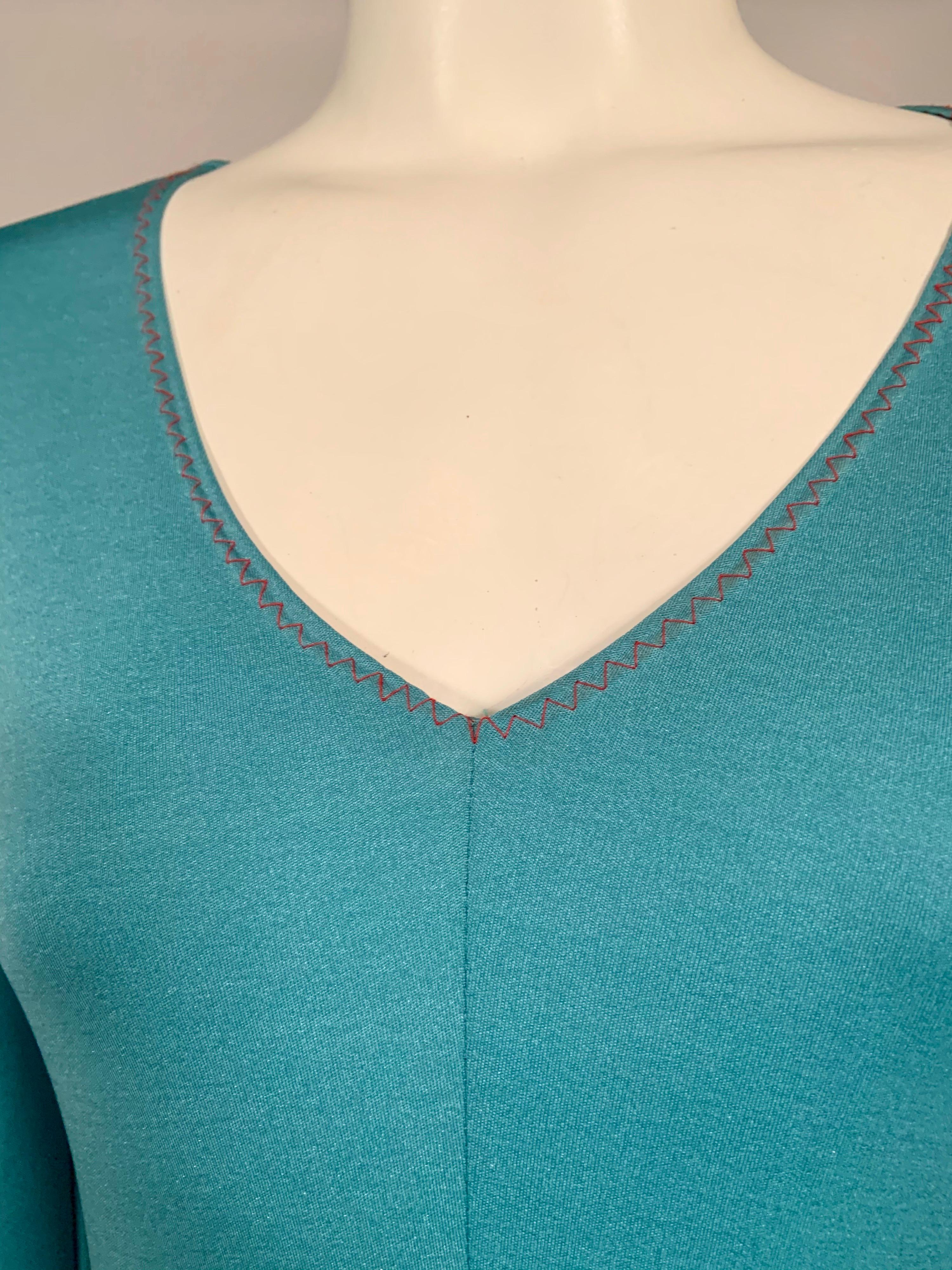 Stephen Burrows, an African American designer created this beautiful aqua blue jersey dress with his signature red zig zag stitching and lettuce edge hem in the 1970's for his lingerie line, Stevies. The clothes are feminine and sexy with a clingy