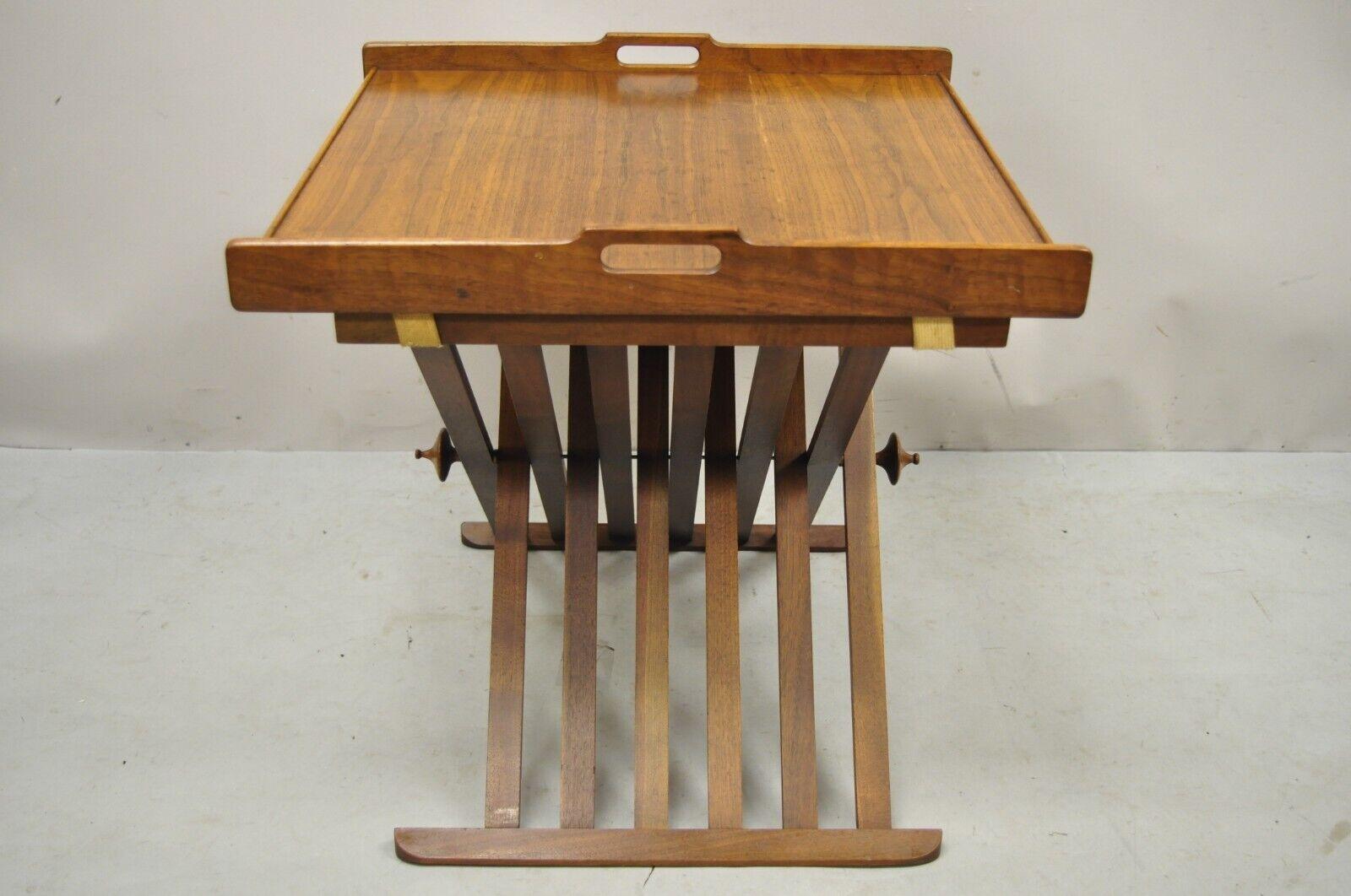 Stewart MacDougall Kipp Stewart Drexel Walnut Folding Campaign Table (A). Item features a removable tray top, folding X-form base, carved finials. Circa mid 20th century. Measurements: 20