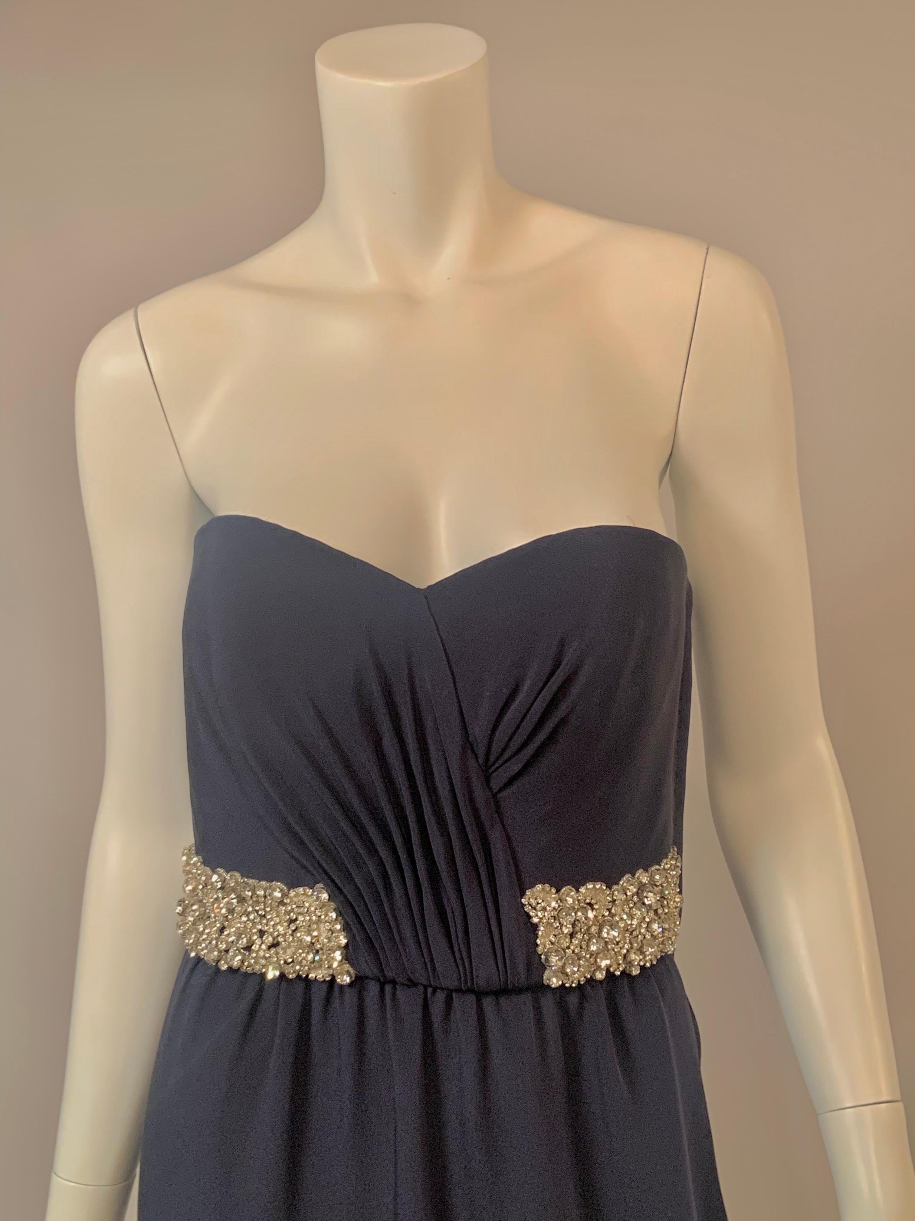 Stewart Parvin is a London based designer a Royal Warrant from the Queen, and this dress is a wonderful example of his work.   The strapless gown has a sweetheart neckline with gathering at the center of the bodice. There is a brilliant diamante