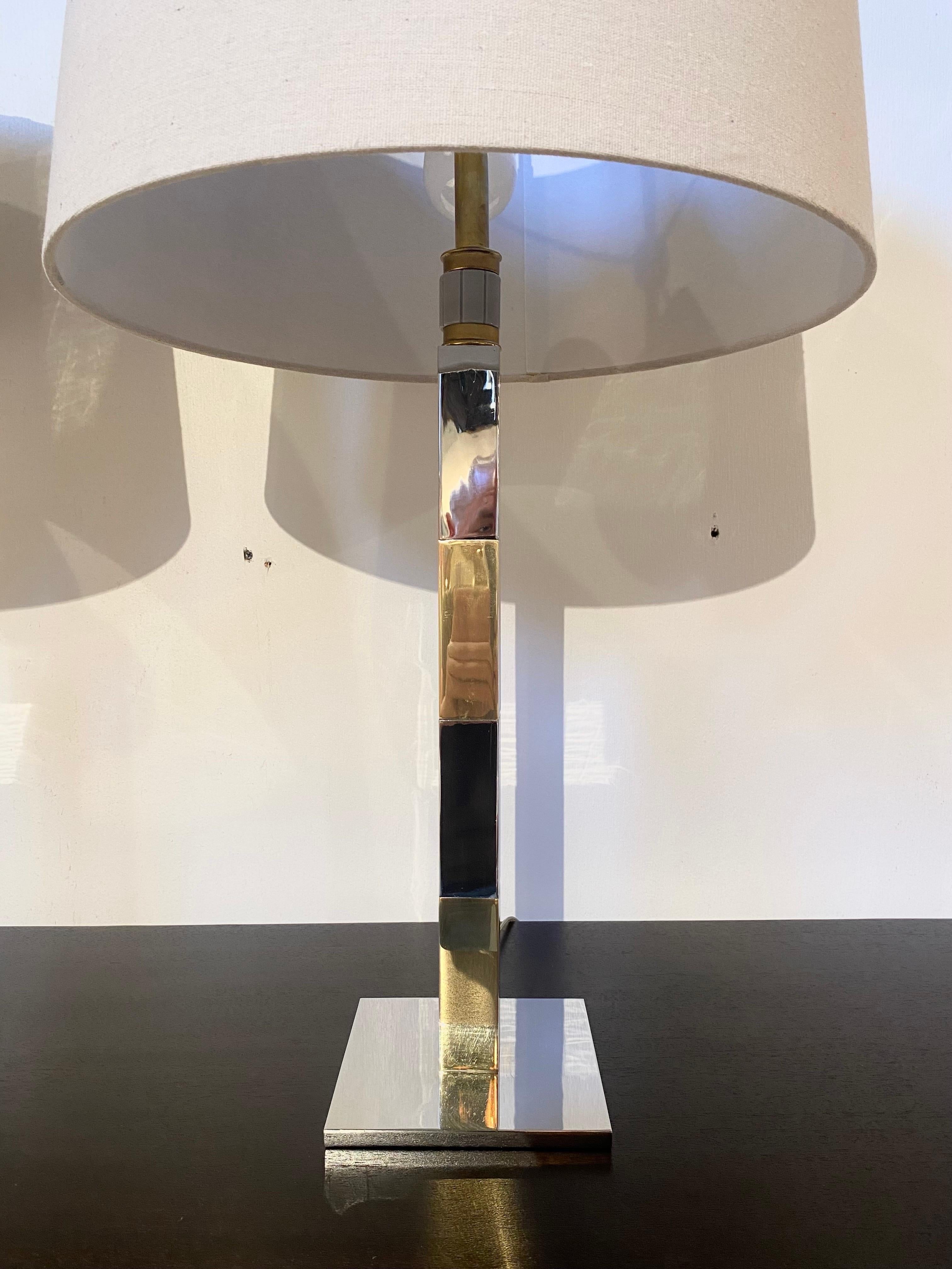 A stunning pair of lamps by Stewart Ross James for Hansen Lighting. These are stacked chrome and brass with the signature Hansen three cluster fixture and rotating three-way switch. Each is in very good condition with minor imperfections as shown.