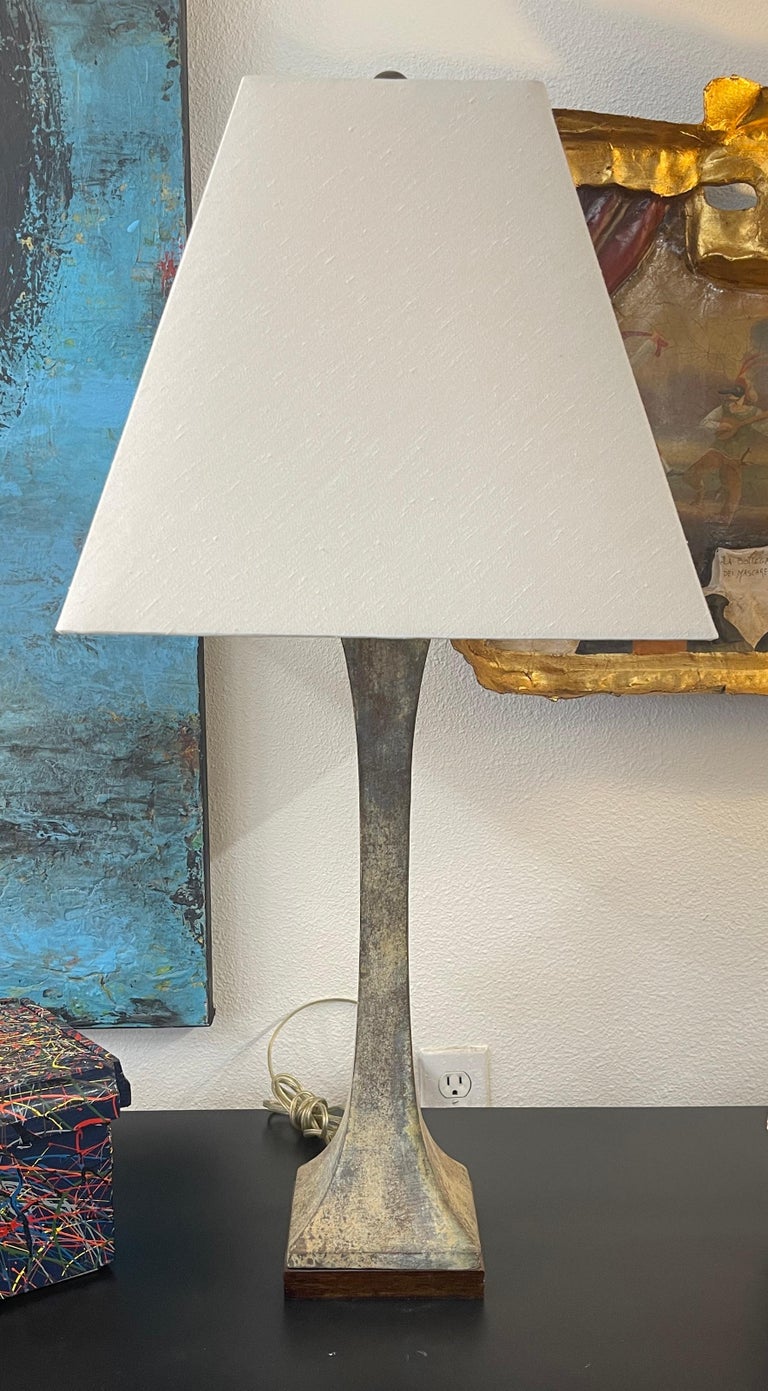 Lovely bronze patinated lamp designed by Stewart Ross James for Hansen. I’m working condition with an older rewire and a double cluster top. Square shade is nice but has some dirt and imperfections. Wood base has some marks. Body of the lamp is