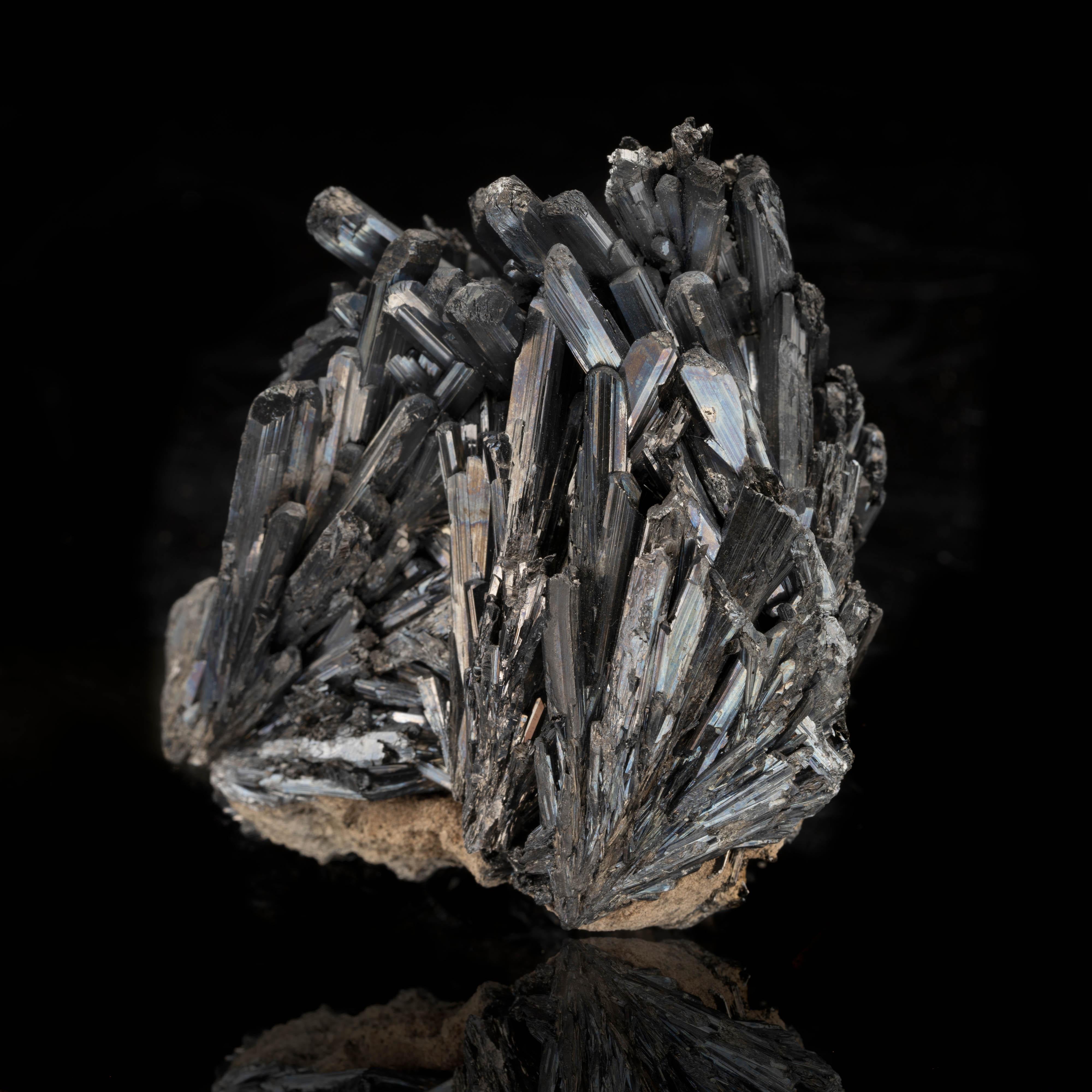 This lustrous 335 g Romanian stibnite cluster features a plethora of beautiful natural terminations and amazing luster. These crystals are striated, sharp, and well-defined. An excellent collector's piece.