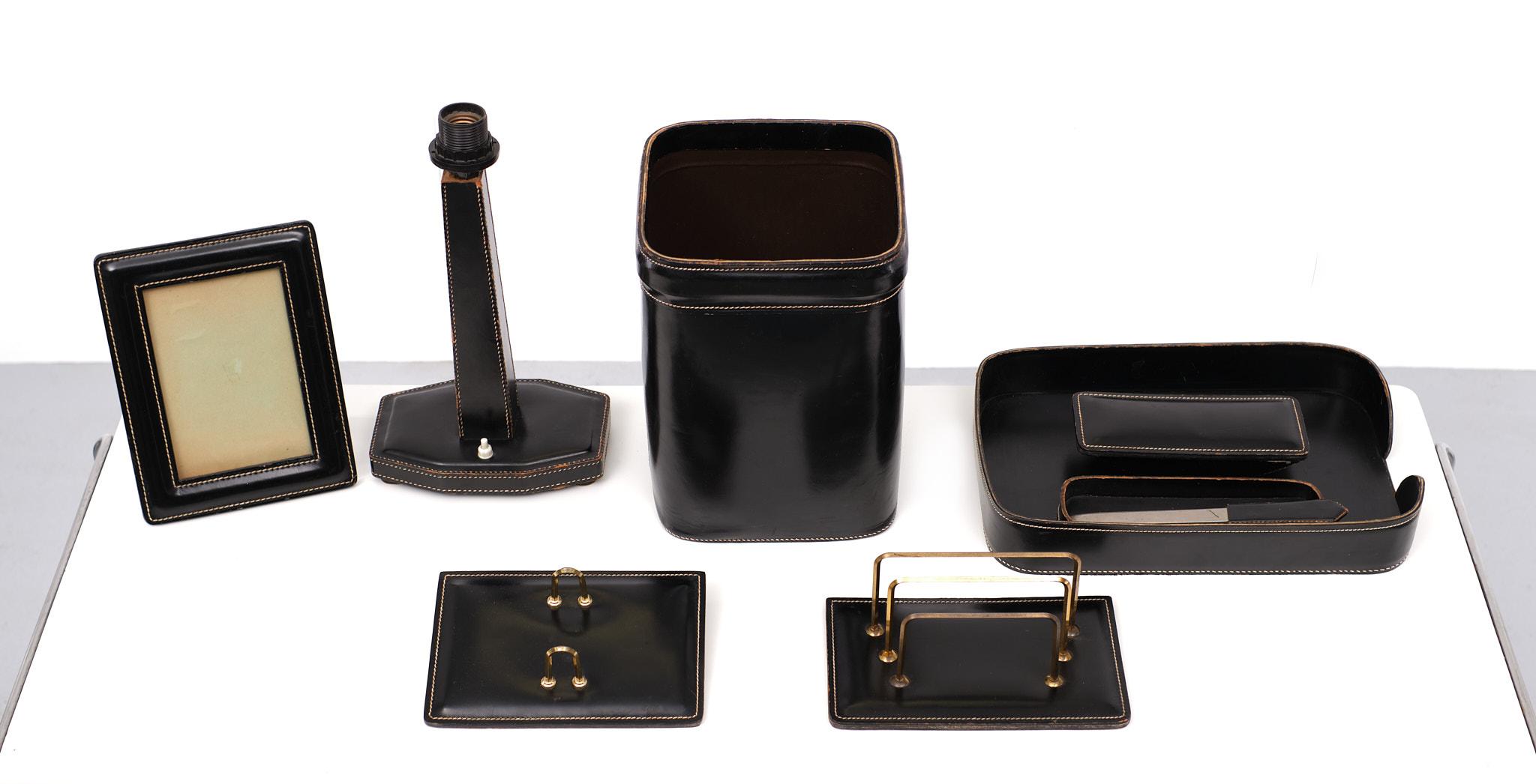 Very nice large set of stich leather desk accessoires. consisting of 
Leather paper basket, Leather lamp stand. leather Picture frame, Leather paper 
rack and several other Desk items.