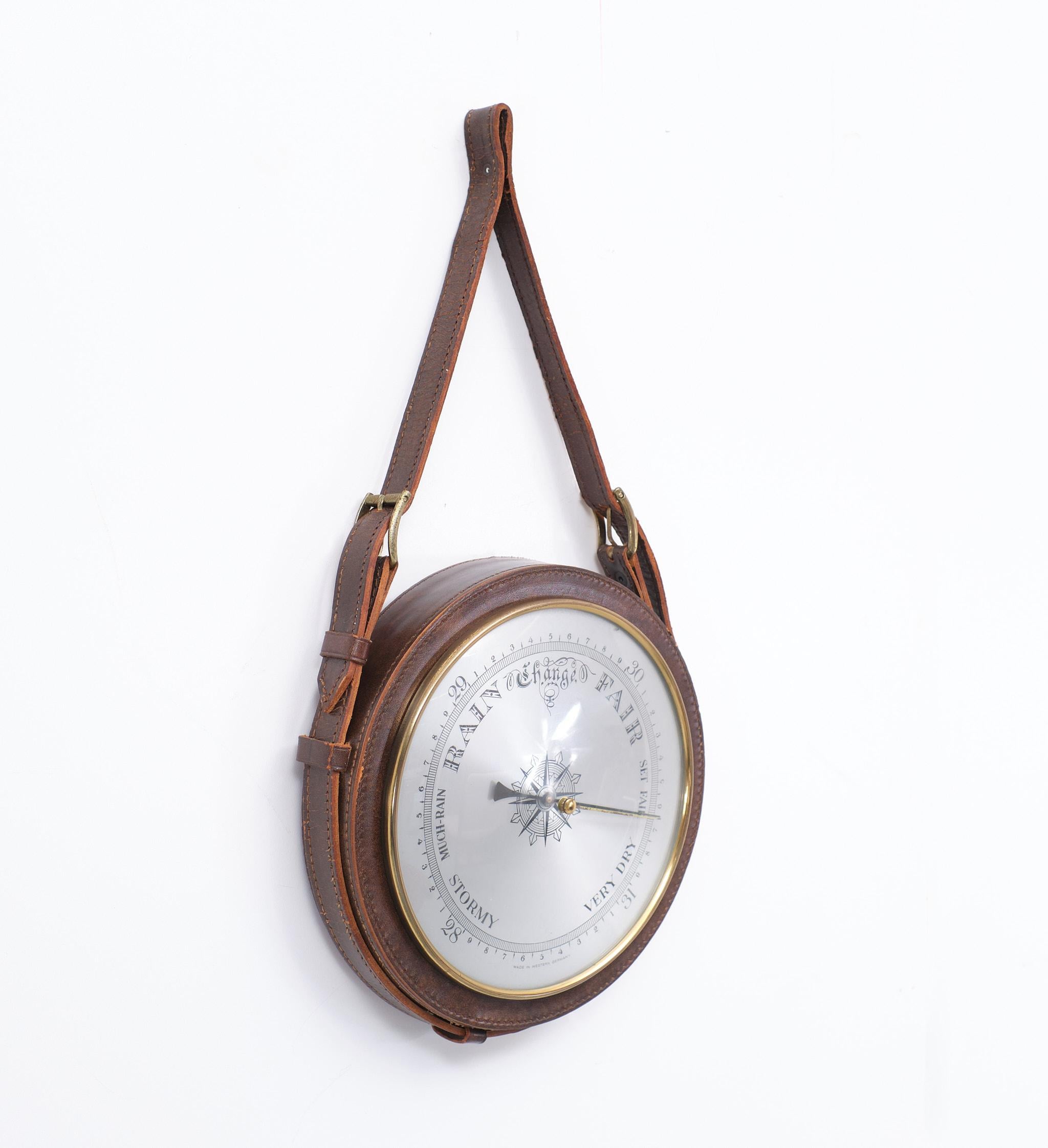 Very nice round hanging Barometer, surrounded with stitch Brown Leather.
Made in Western Germany in the 1960s. Good working condition.