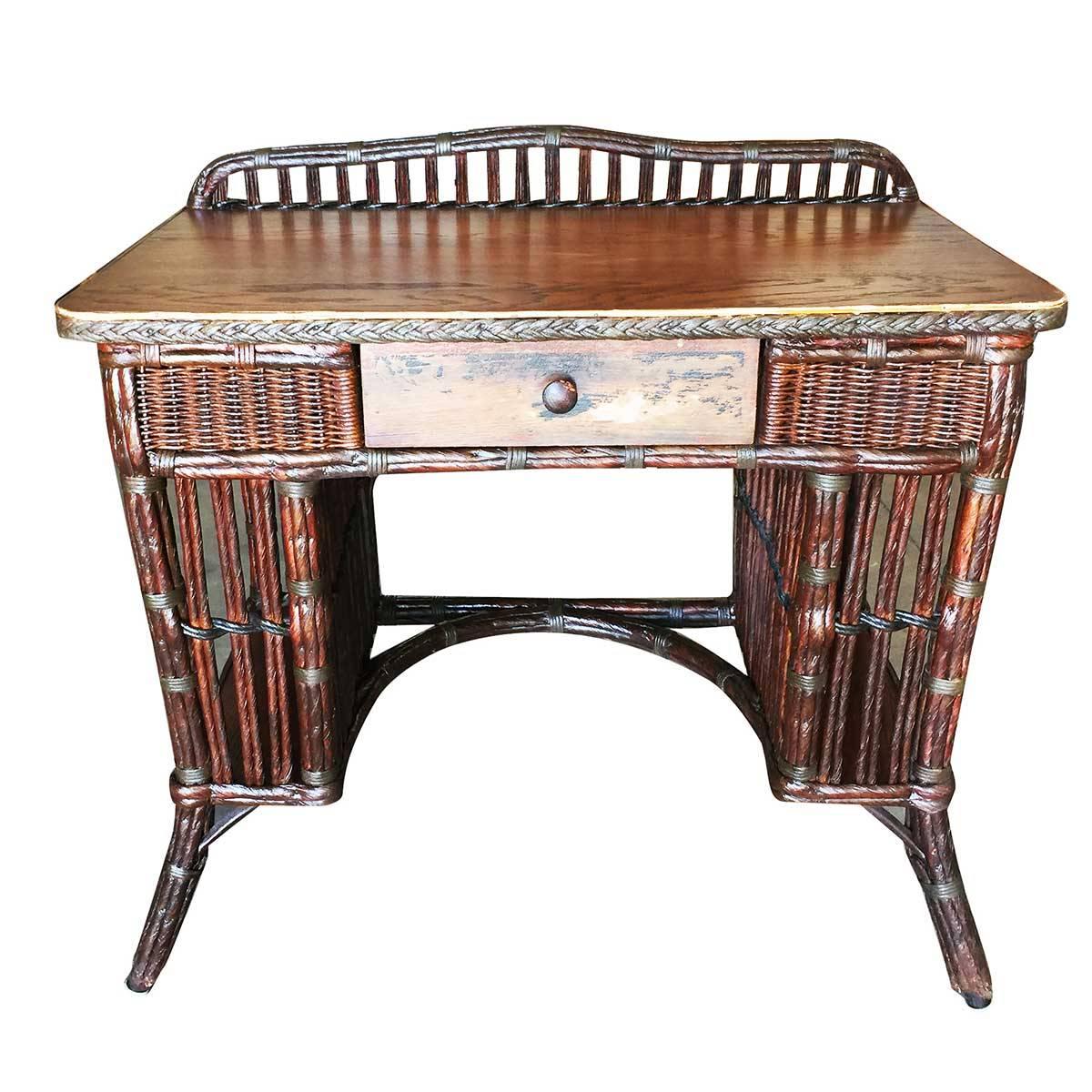 Rare dark stain finished stick rattan desk with a mahogany top. This late Victorian desk has an attached single center drawer for storage and single tier side shelf on each side for further storage. 

Restored to new for you.

All rattan, bamboo and