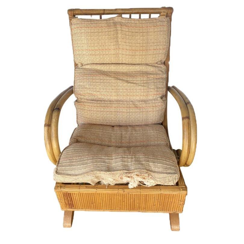 A double-strand arm spring-loaded rattan rocking chair with cushioned back and a rattan stick sided oak base. 
Height: 35