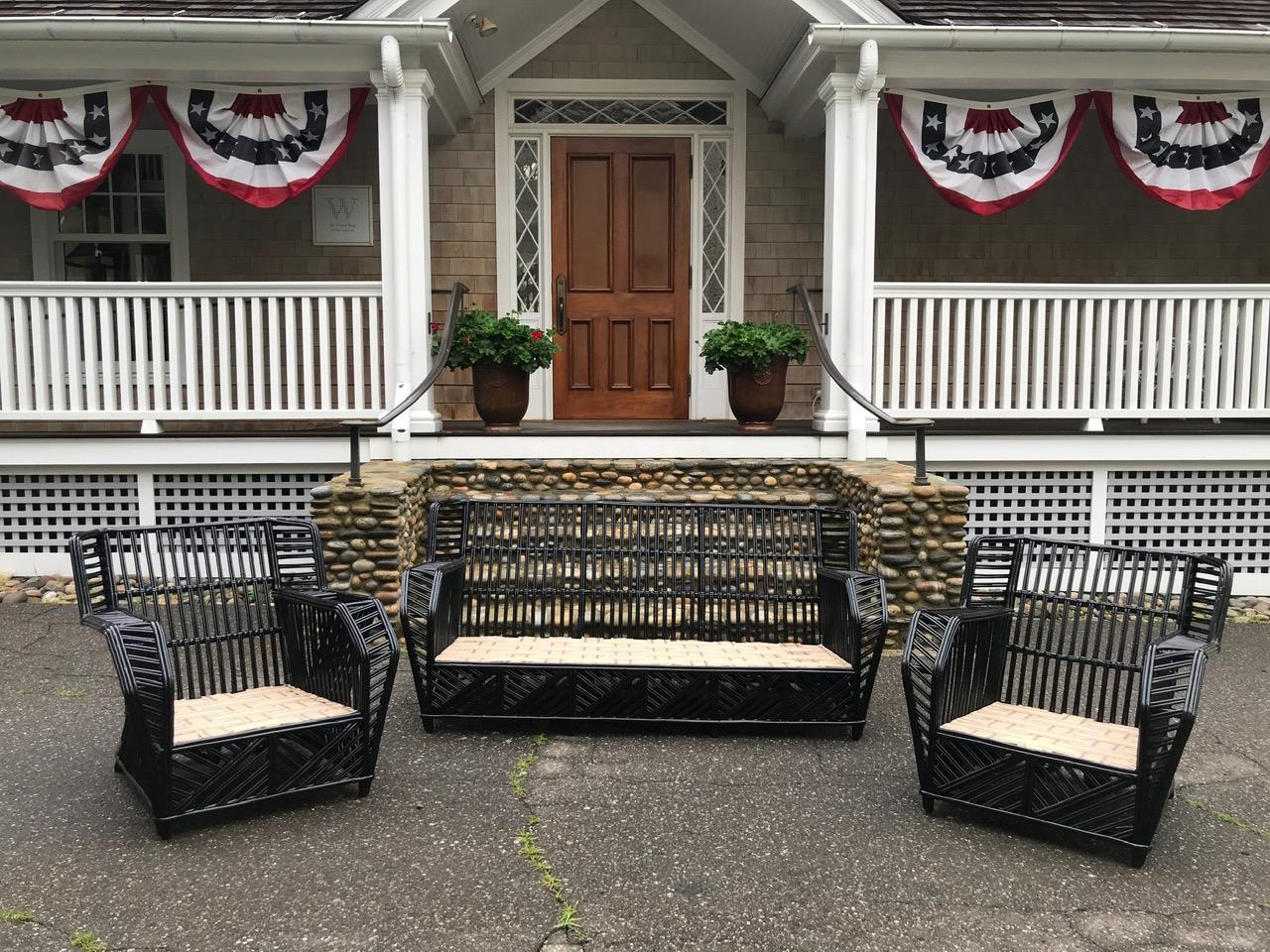 Antique stick wicker porch furniture in fresh black paint. Chevron skirt on four sides of each piece for easy placement. An unusual design in stick wicker. Sofa measures 70