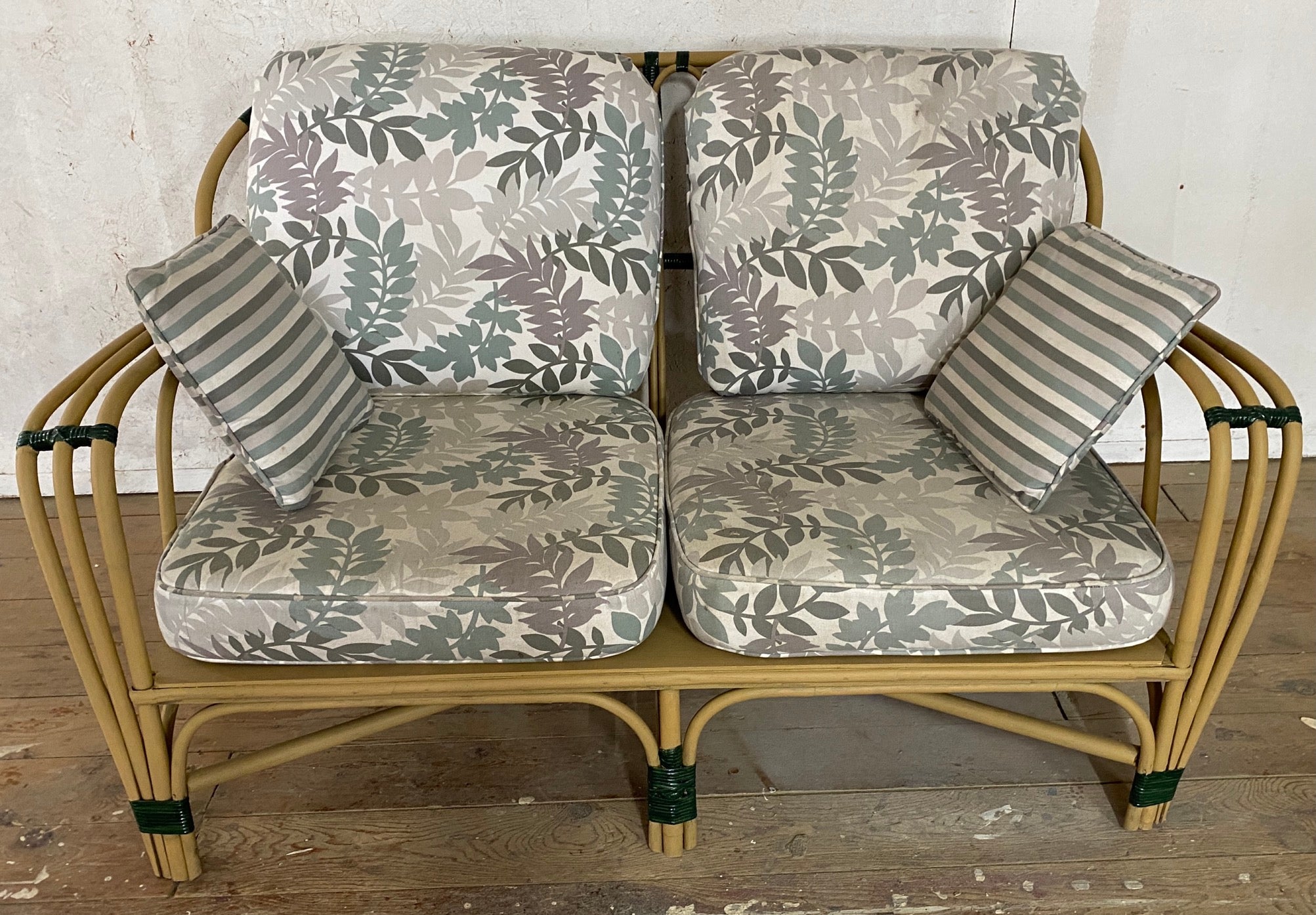 Three-piece Art Deco stick wicker / split reed set consists of two-seat sofa/settee and two matching club chairs. Wonderful design with wide arms, light yellow paint and green accent.
Measures: Arm H = 23.25/ H w/cushion = 15.75
Chair = 37.75 D x
